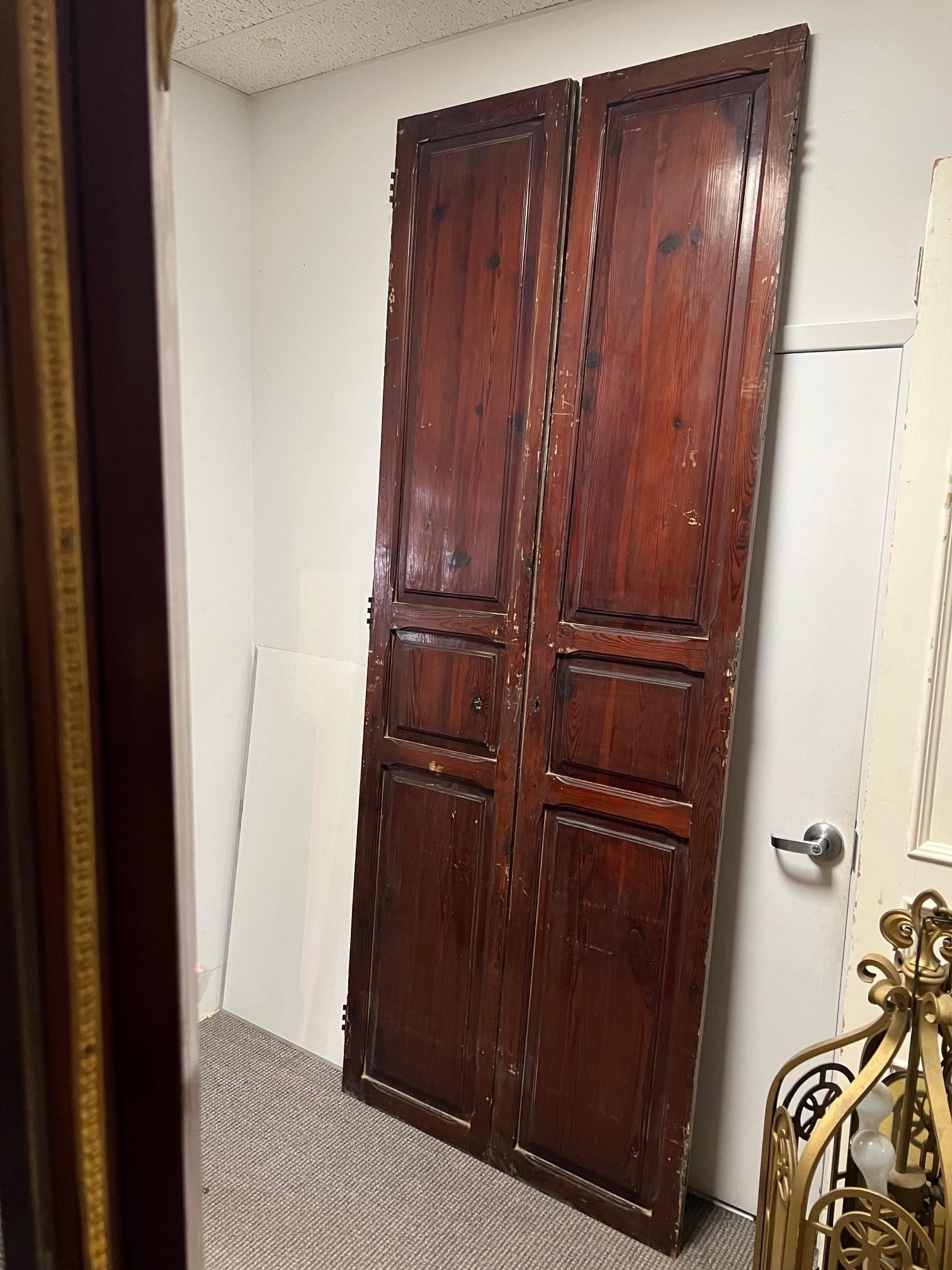 A nice tall pair of interior doors imported from Europe in the late 1990s. The doors are simple with three raised panels on one side and three flat panels on the other side. A great size only 20