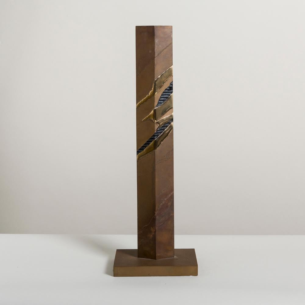 A tall patinated steel sandstorm inspired table sculpture with polished brass accents, 1980s
