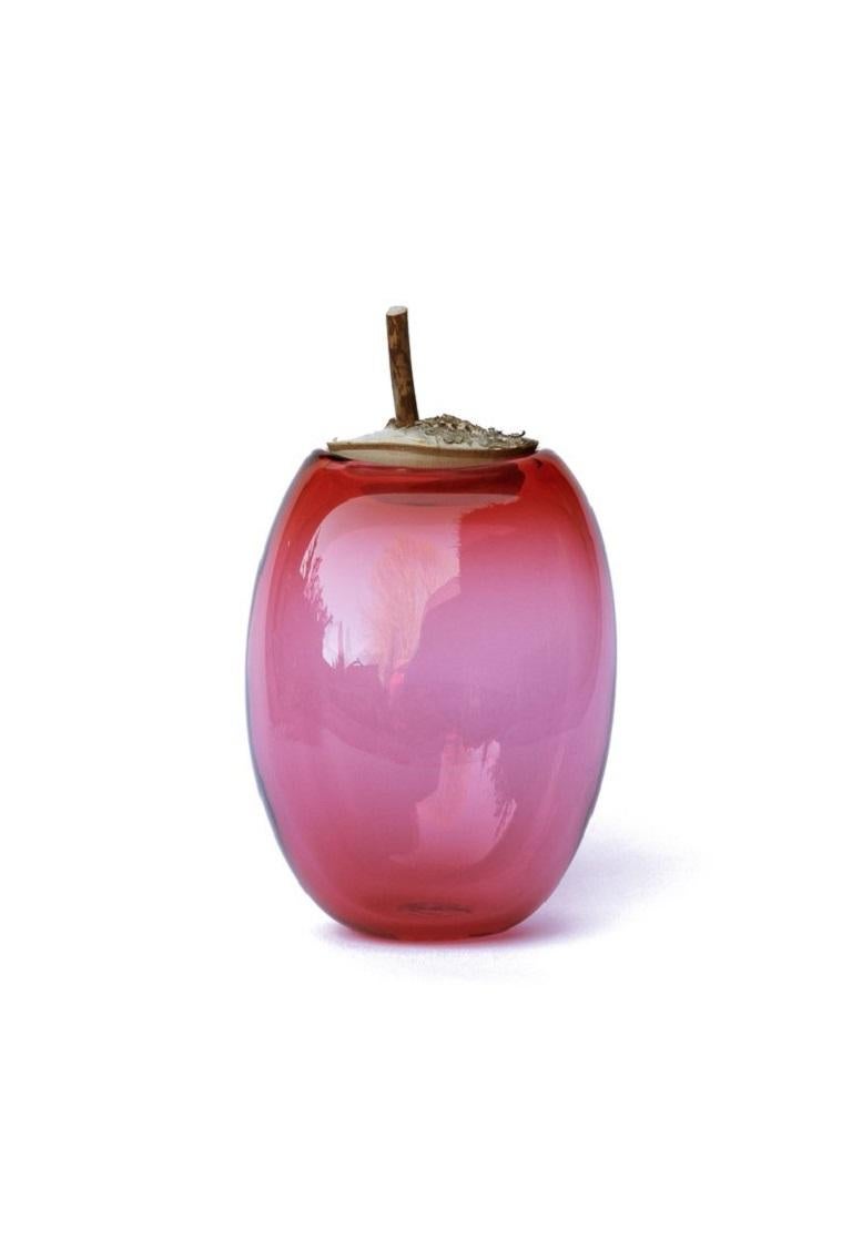 Tall Peach Branch Bowl, Pia Wüstenberg
Dimensions: D 16-18 x H 24
Materials: glass, wood
Available in other colors.

A playful jar, with a lid made from a branch stub following the curvature of the glass. Branch Bowls are blown without a mould: