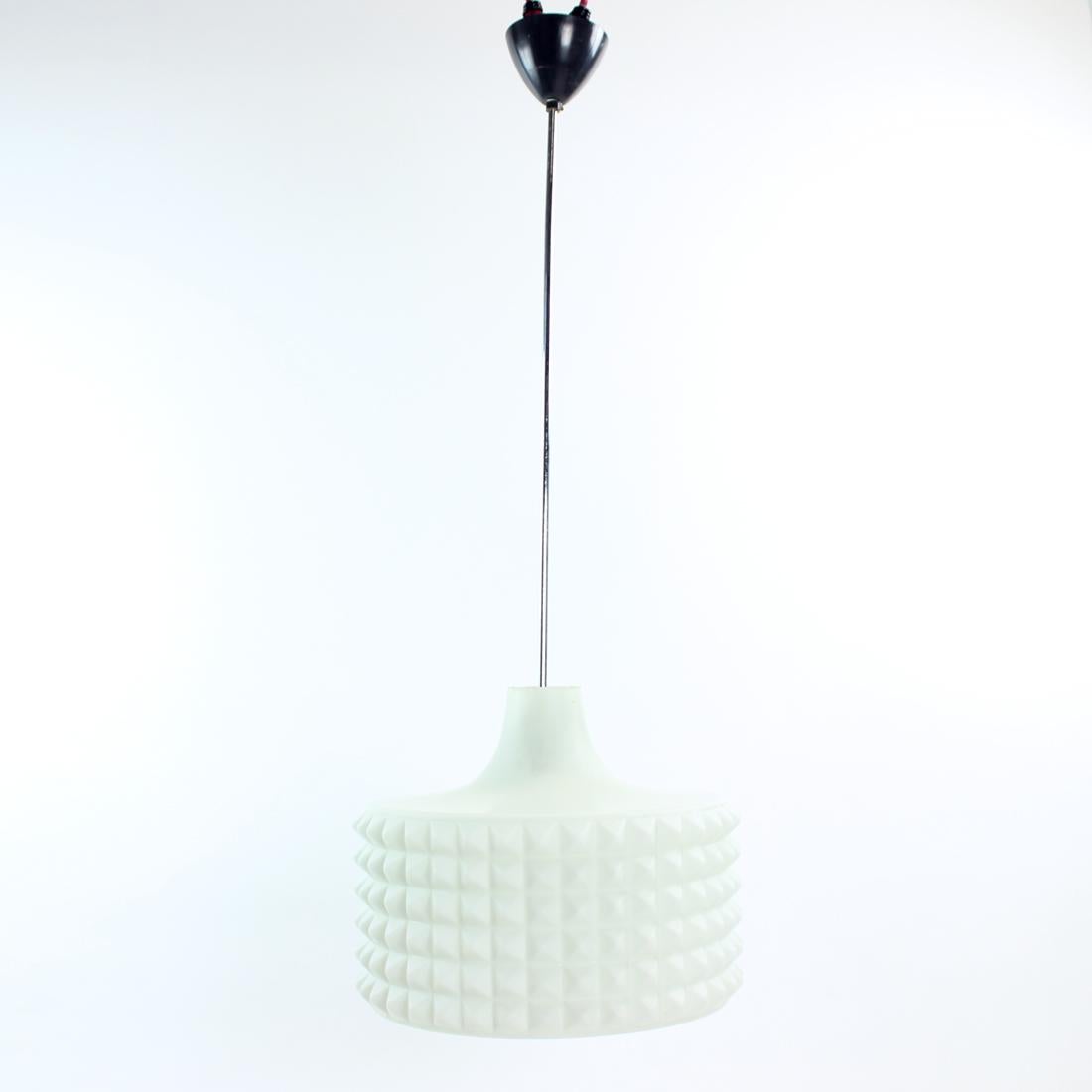This is a beautiful, tall pendant produced by Napako company in Czechoslovakia in 1960s. The pendant design is elegant and clean with typical Mid-century design on the white glass shield. The shield shows beautiful details and is simply made of pure