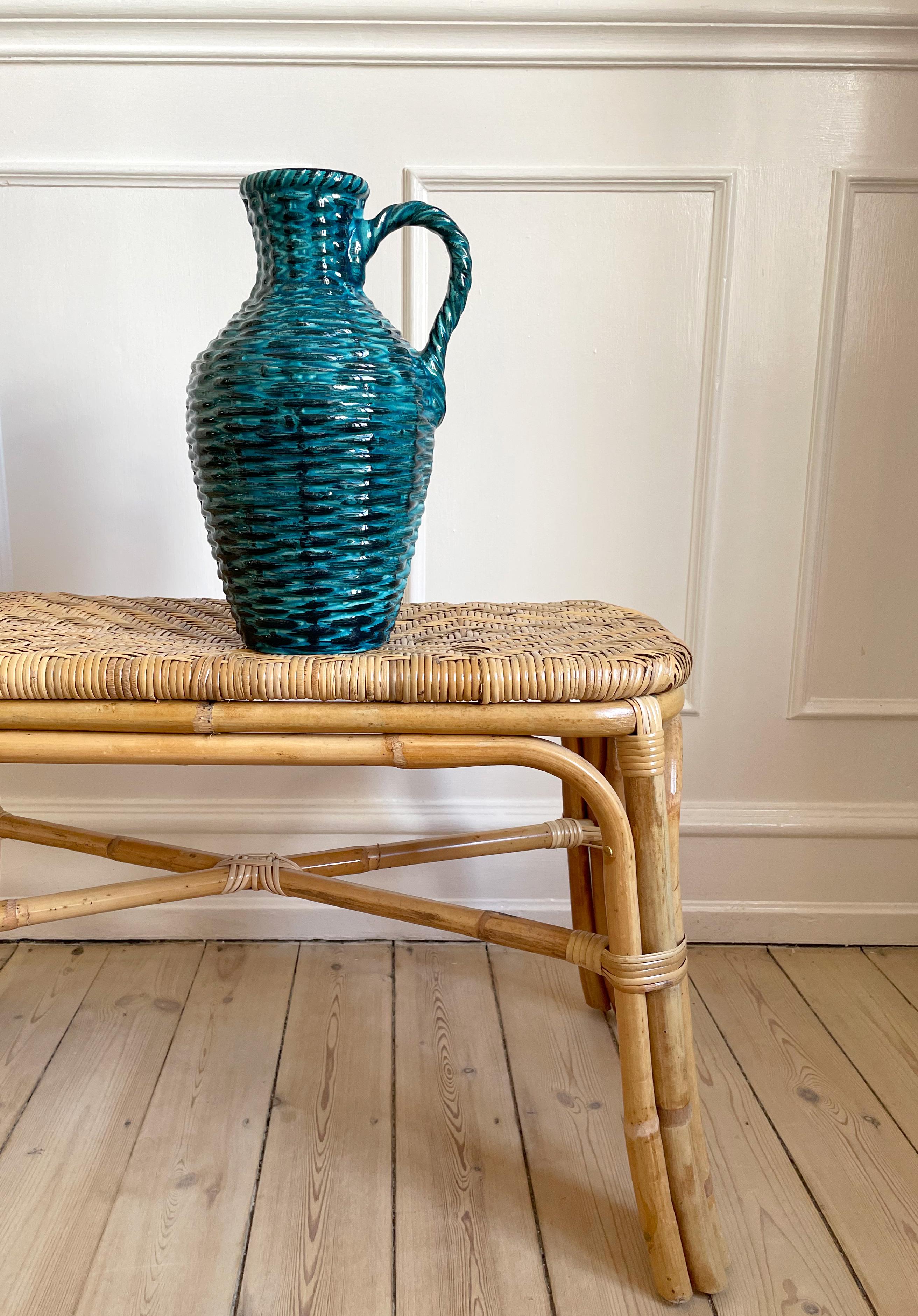 Large hand-painted petrol turquoise pastel blue and black glazed ceramic vase with visible brush strokes and unusual soft organic texture resembling interwoven rattan or bamboo. Braided top and handle. Dark caramel brown glaze on the inside.