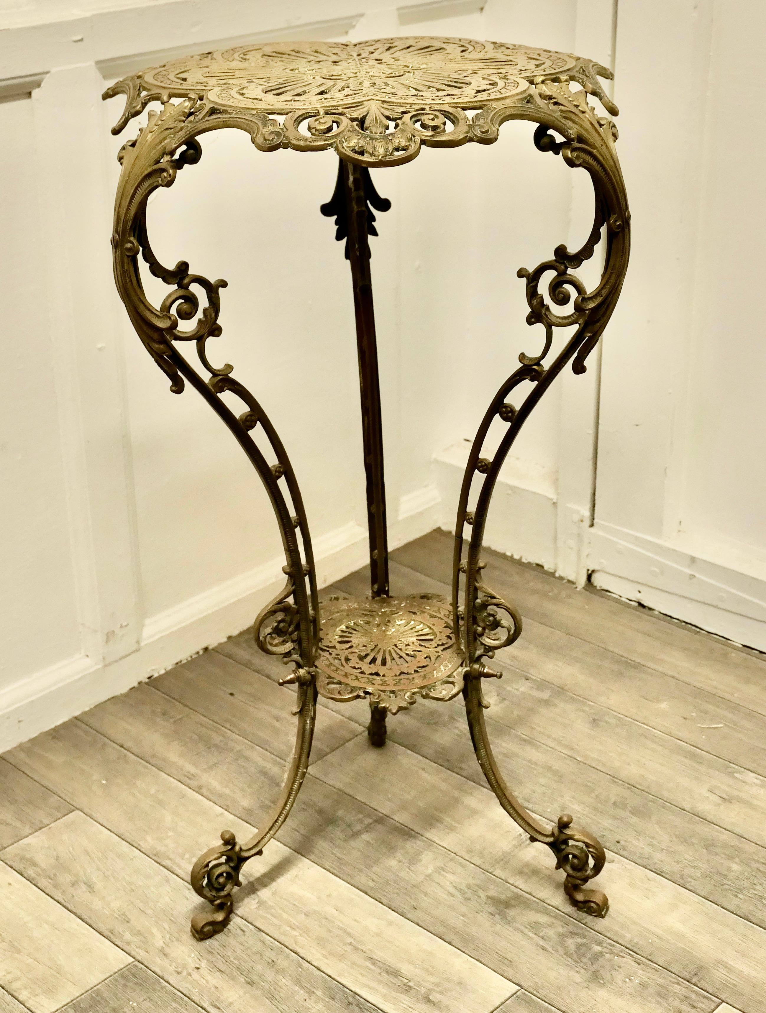 Tall Pierced Brass Plant Stand Table

A superb piece tall and elegant, the table is made in solid brass and very decorative, it has 3 scrolling legs and an undertier. The table has a floral theme to the decoration with acanthus leaves and scrolls