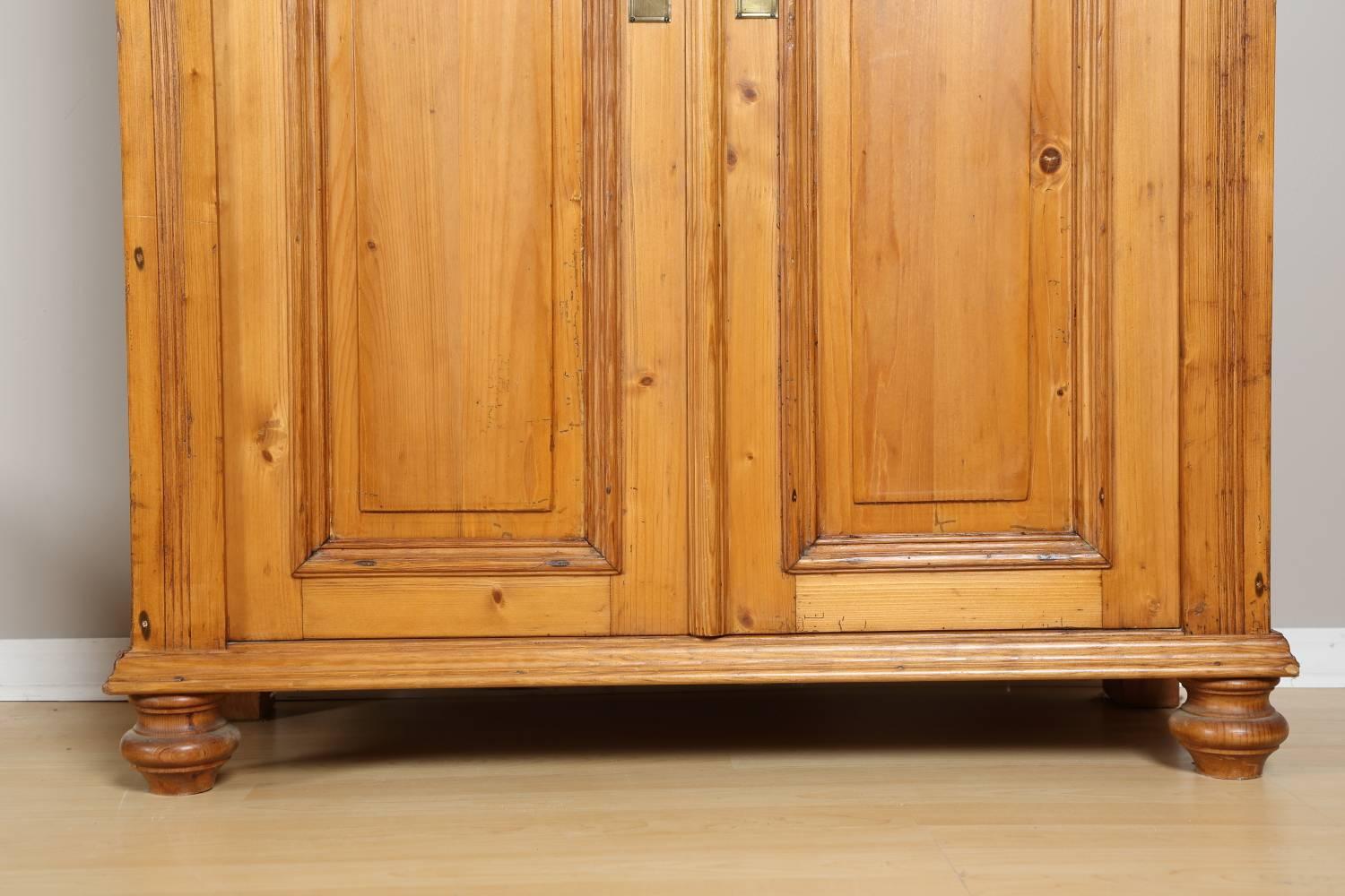 Tall pine cabinet, circa 1880. Tall pine tree cabinet from Germany with double doors and top drawer. The cabinet has been restored and finished with wax. All keys are included. Complimentary delivery and set up within 100 mile radius from Chicago,