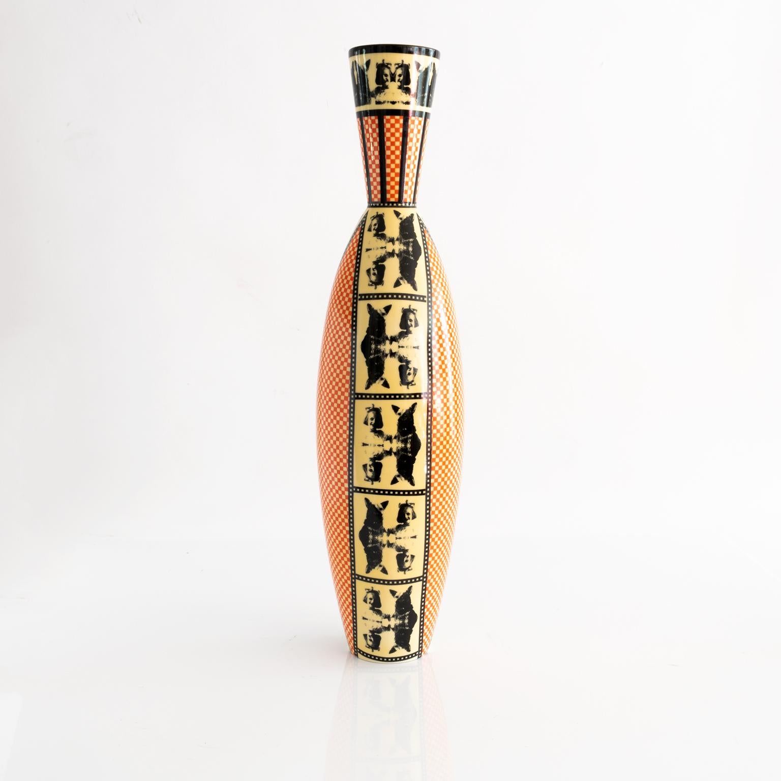 A tall porcelain Åsa Lindström vase for Rörstrand, decorated with a repeating pattern of a young girl with dog and an orange and yellow chequer pattern. Signed Rörstrand, Åsa Lindström, circa 1990.

Measures: Height 20.5