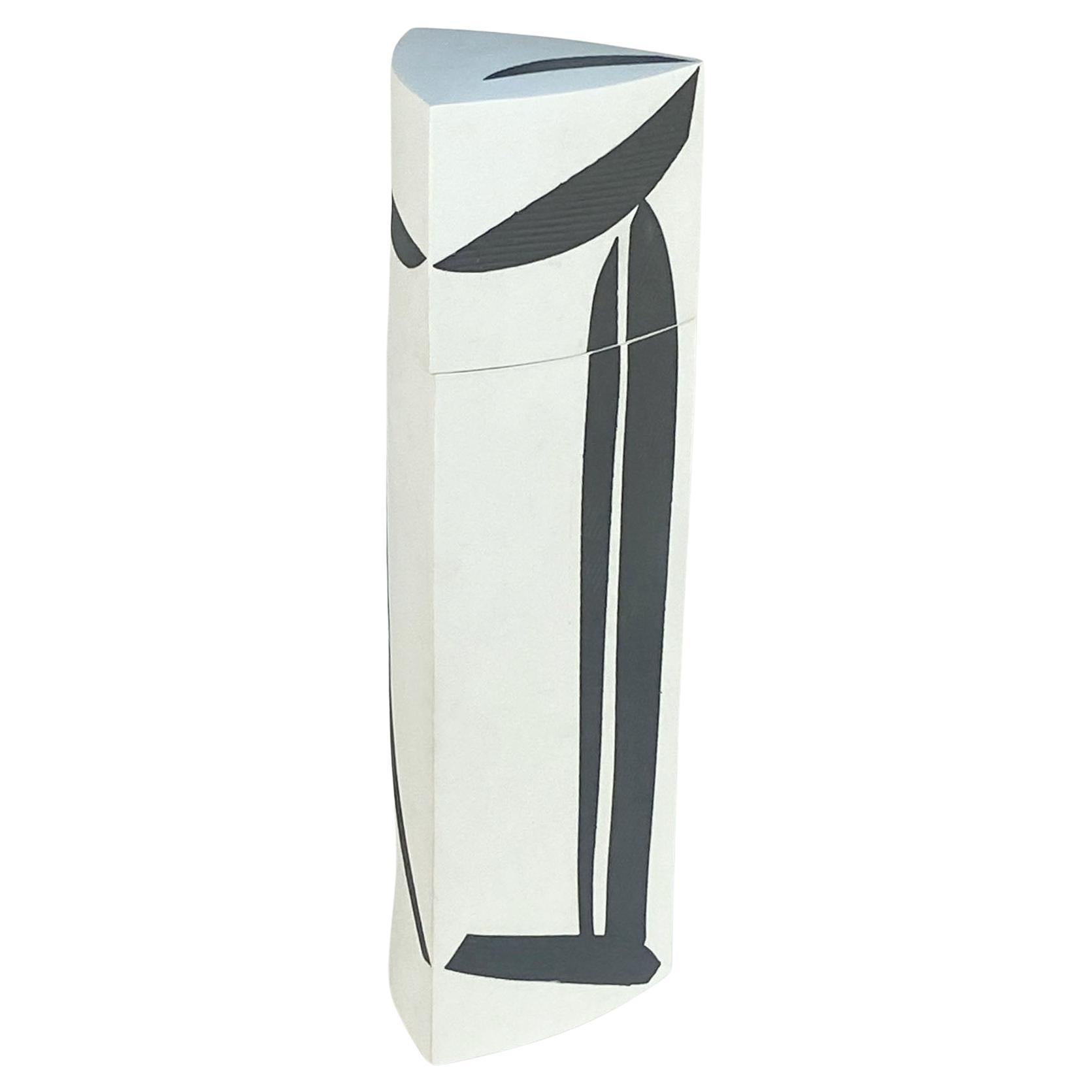 Tall ornamental art vessel in triangular form with lid is hand formed in porcelain by international acclaimed ceramist Jutta Albert (B 1954, Germany). The white un-glazed body is elegantly decorated with inserted indigo porcelain relief shapes,