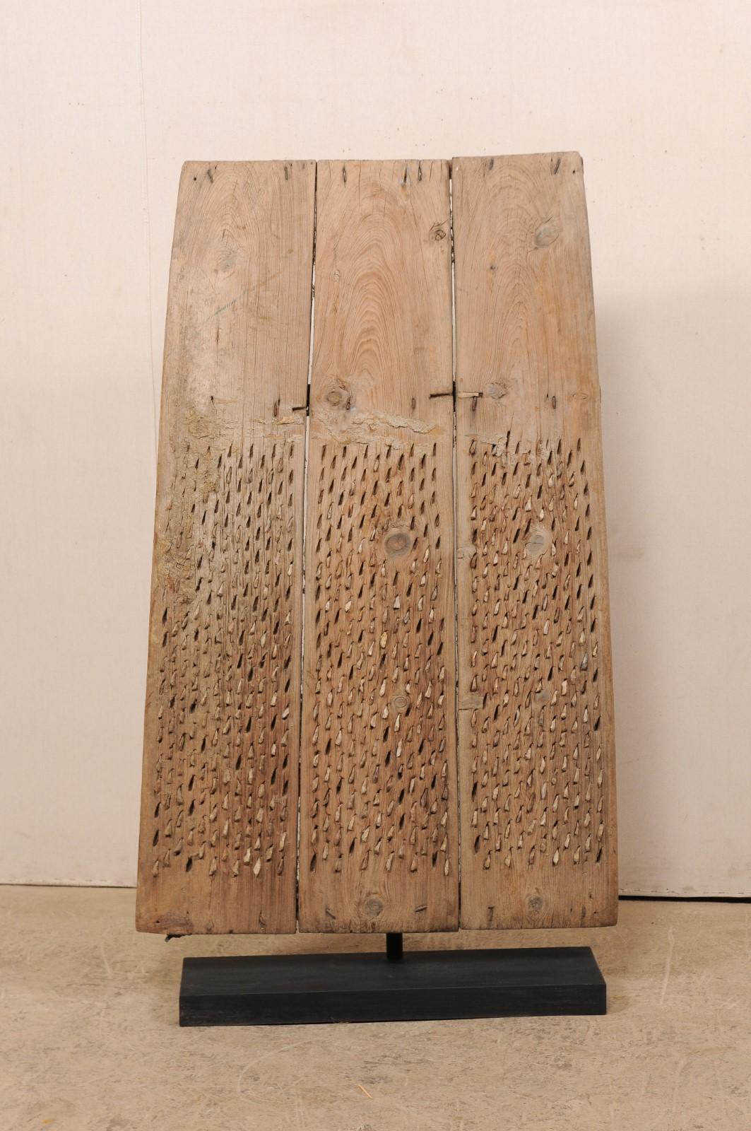 A Turkish agricultural threshing board from the early 20th century. This antique threshing board from Turkey is a particularly nice example, having three wooden boards (often you will see smaller ones, made up of two boards). The thick boards, when