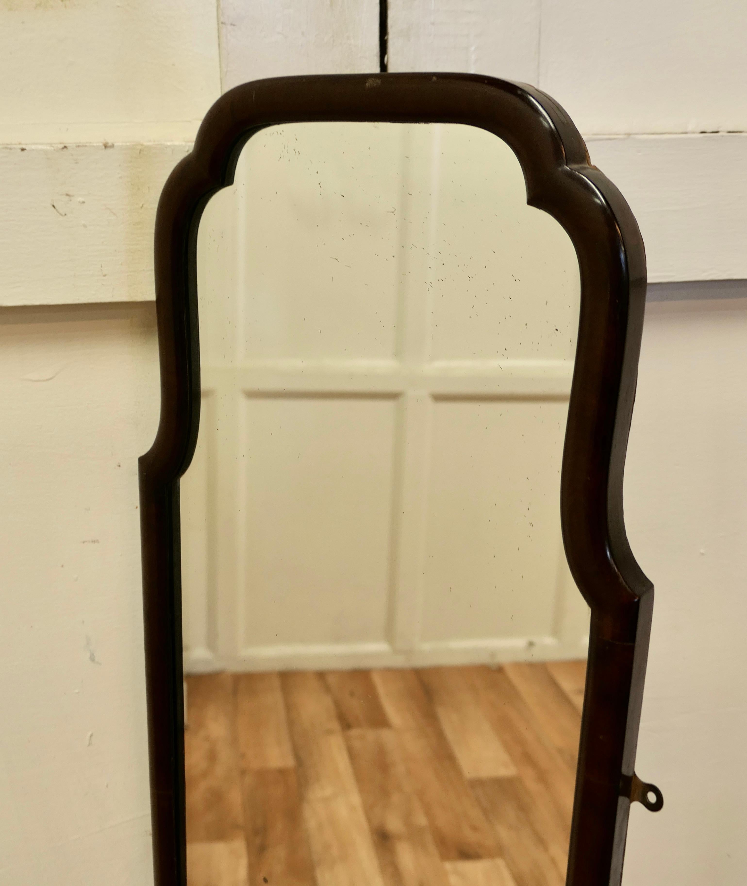 Tall Queen Anne style wall hanging dressing mirror 

The Mirror has a simple moulded 1” wide Frame with a scalloped shape to the top
The Glass is in good condition and it has a good wooden back 
A good mirror will always add light and elegance