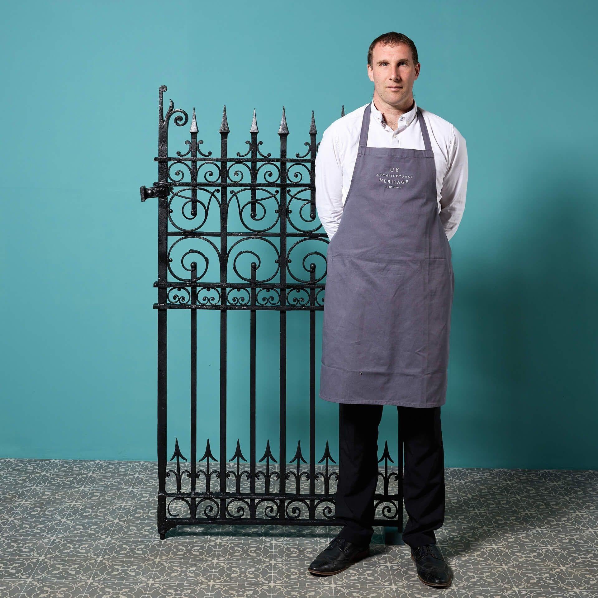 A tall reclaimed Victorian era wrought iron side gate, ideal for adding security and style to a walled garden or side alley of a house. Dating from the late 19th century, this antique pedestrian gate’s traditional blacksmith-made craftsmanship has