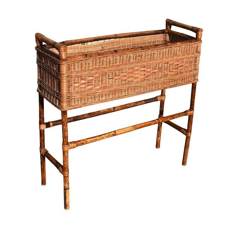 A large Victorian bamboo and wicker standing basket planter. This lovely chinoiserie piece will be fabulous on a covered patio, front porch or inside by a window. The base is created from lovely torched black and brown bamboo. The top is rectangular