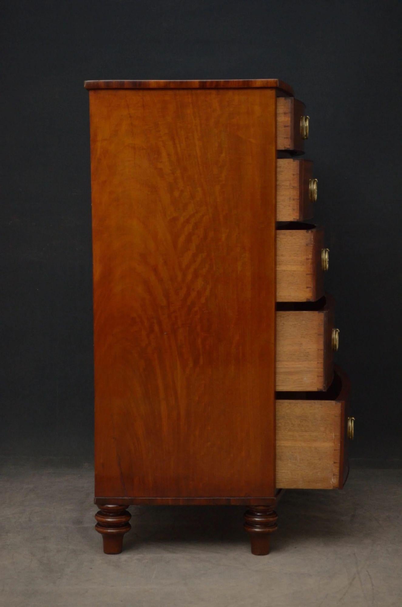 Sn5107 Tall Regency, bow fronted chest of drawers in mahogany, having figured mahogany top above five graduated and cockbeaded drawers, all fitted with original brass ring handles, standing on original turned feet. This antique chest of drawers