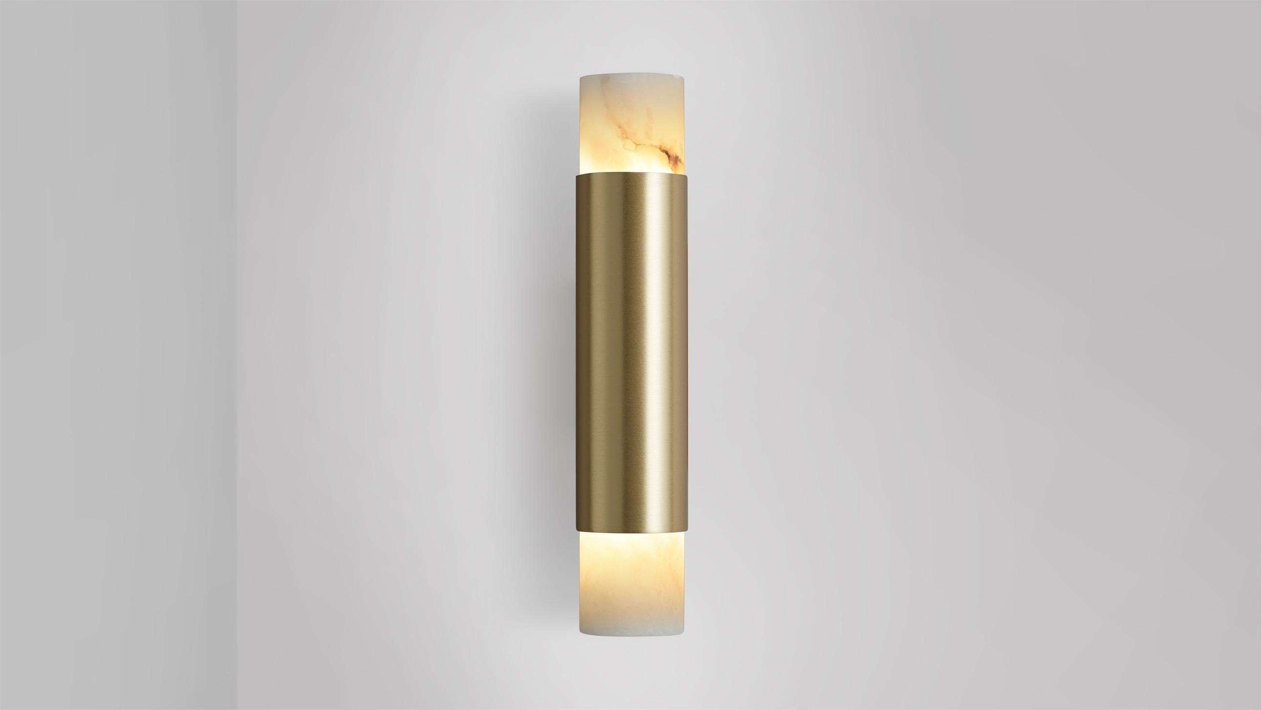 Tall Roma wall lamp by CTO Lighting
Materials: satin brass, alabaster.
Dimensions: D 8.5 x W 5.5 x H 28 cm
Available in satin brass and bronze.

Celebrating the simplicity of line and form, The Roma collection is designed to highlight the noble