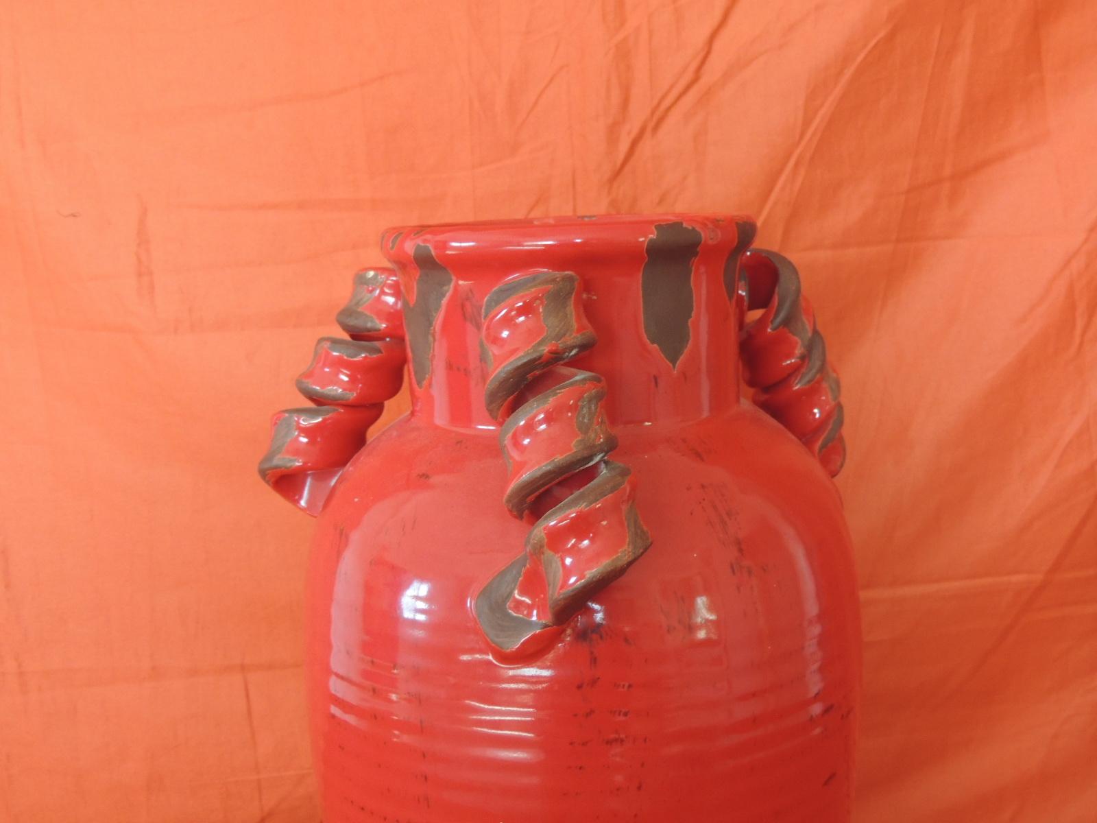 Tall round Asian glazed red vase/urn with twisted handles.
All cracks and chips are the design of the Jar.
Size: 9