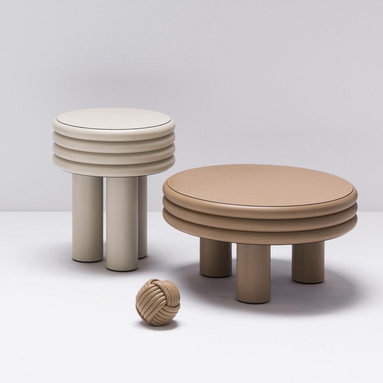 Contemporary tall round leather side/coffee table - Scala by Stephane Parmentier for Giobagnara. 
The object presented in the image has following finish: F95 Off White Nappa Leather

The inspiration behind the Scala Collection designed by