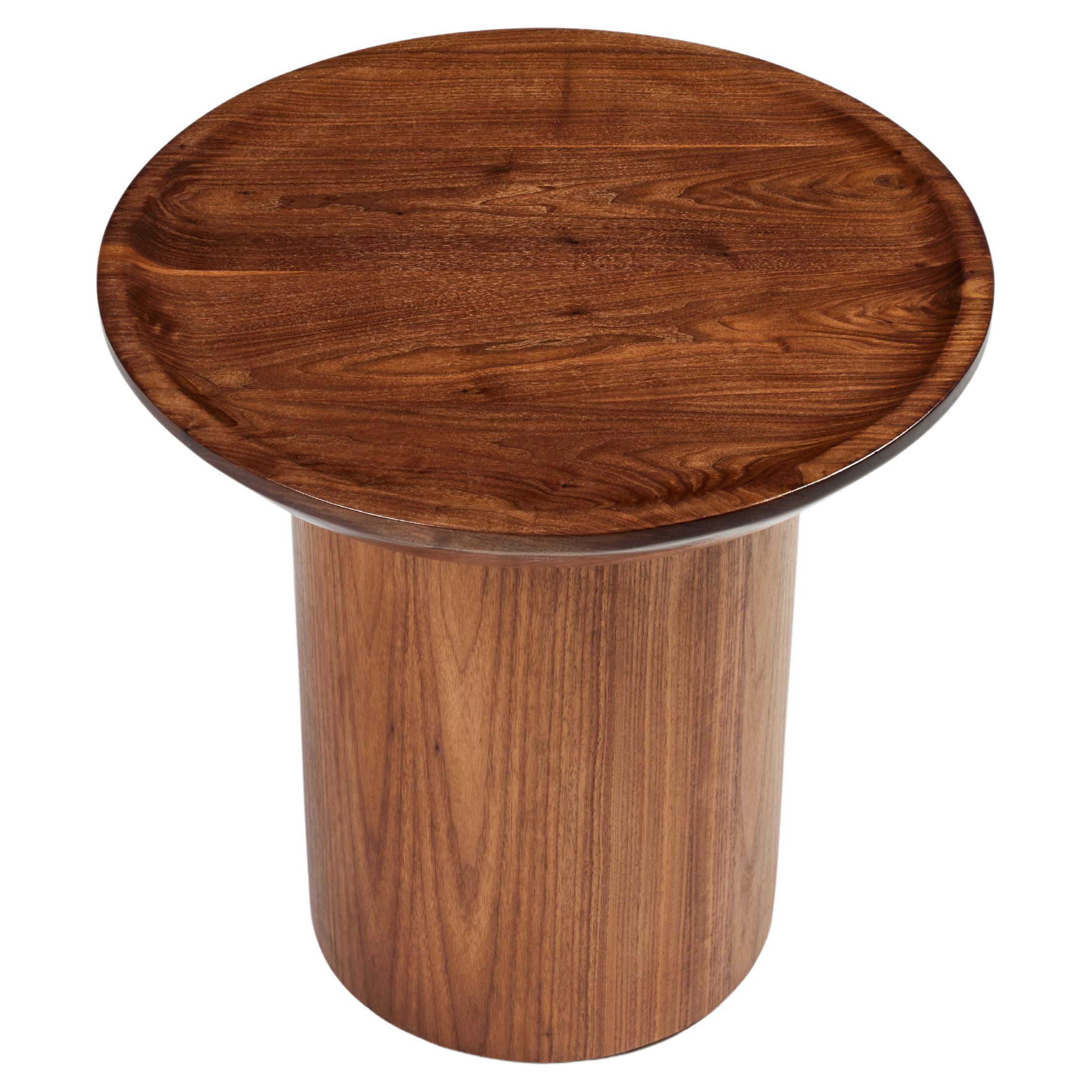 Martin & Brockett 's tall round findley side table is shown here in walnut. Carved curved lip edge on table top. Round base.
Each piece is individually crafted, slight variations in color, finish and grain may occur.
Lead time 10-12 weeks. As global