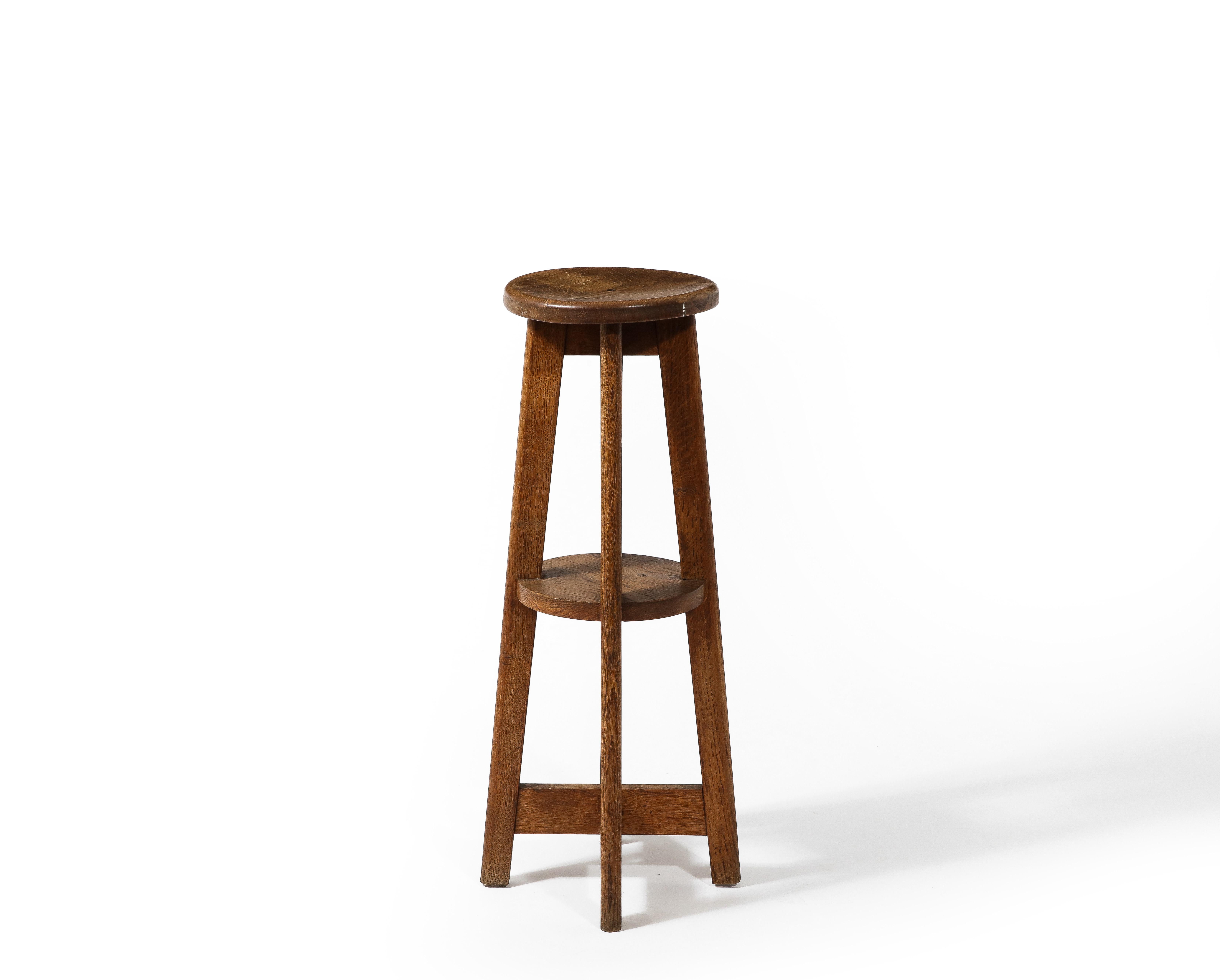 Two-tiered solid oak vintage stool. Excellent to use as a pedestal for the display of objects. Solid construction. 