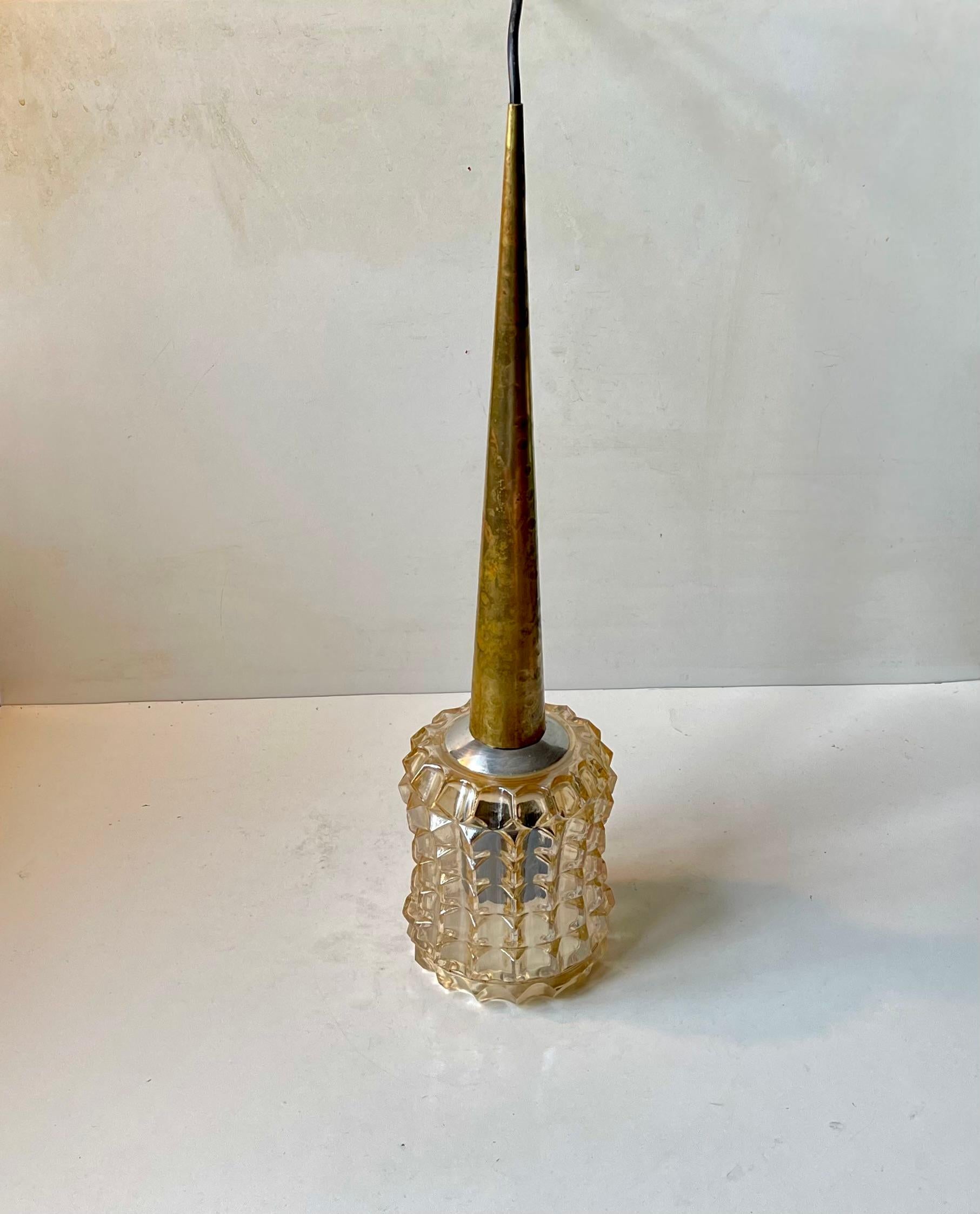 Tall and spiky hanging light featuring a lightly hammered brass top and a pressed smoke glass shade. Anonymously manufactured in Scandinavia during the 1960s. Measurements: H: 50 cm, Diameter: 13 cm. Working and tested vintage order. Comes installed
