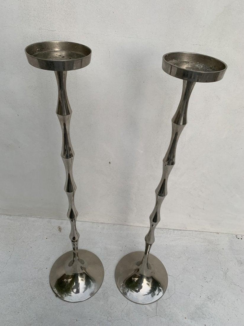 Beautiful, tall and slender, good condition set of tall candleholders made in stainless steel.
The pieces show well and we will polish them before shipping.
Measurements:
 27.50 inches high x 7 inches base diameter x 4 inches top diameter.