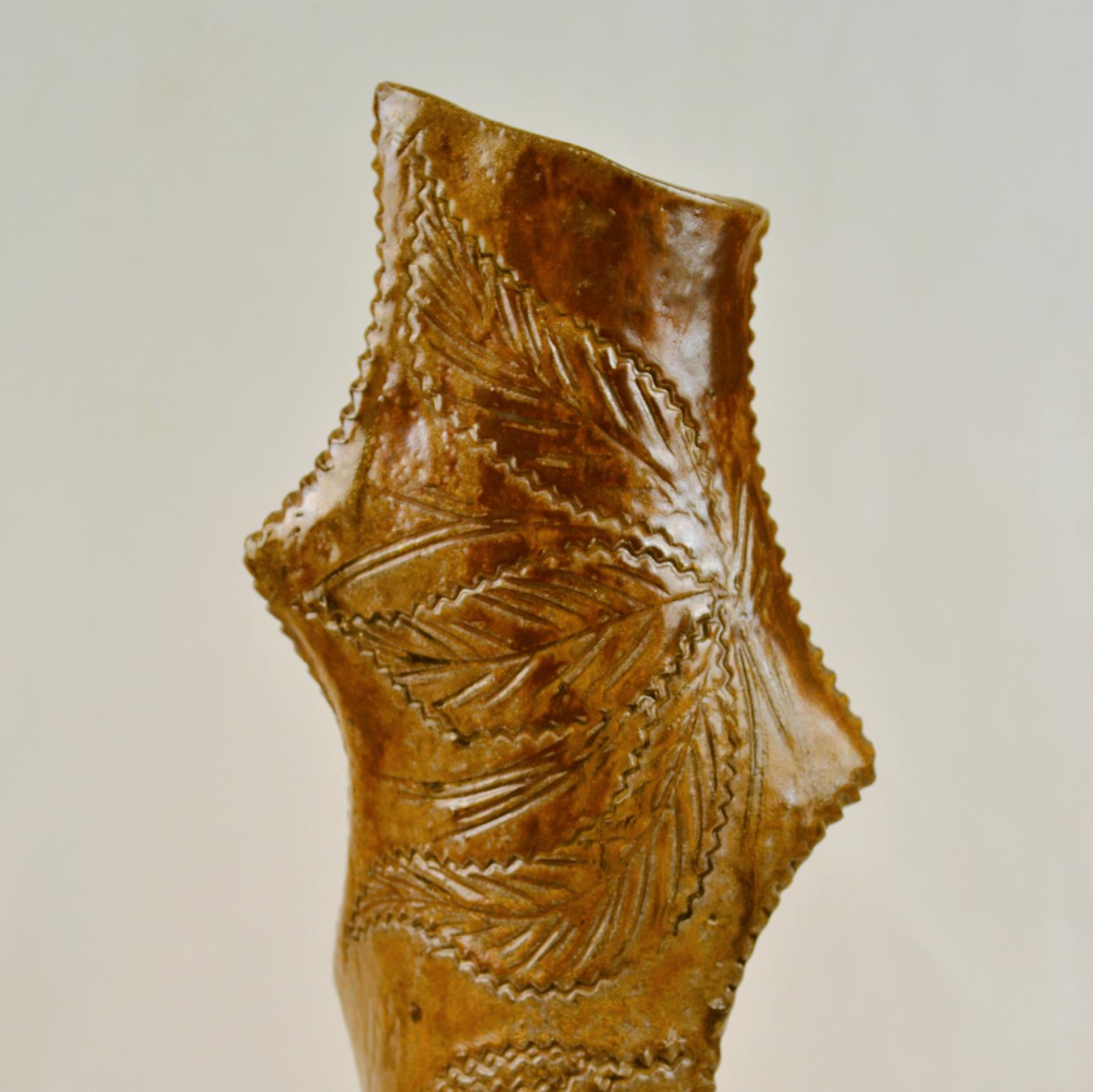 Tall sculptural studio pottery floor vase, sculpted and decorated in the manner of traditional Dutch Frisian Art Pottery. This 1970's decorative vase is glazed in mustard, brown with and the deep textured surface with intricate pattern comes alive