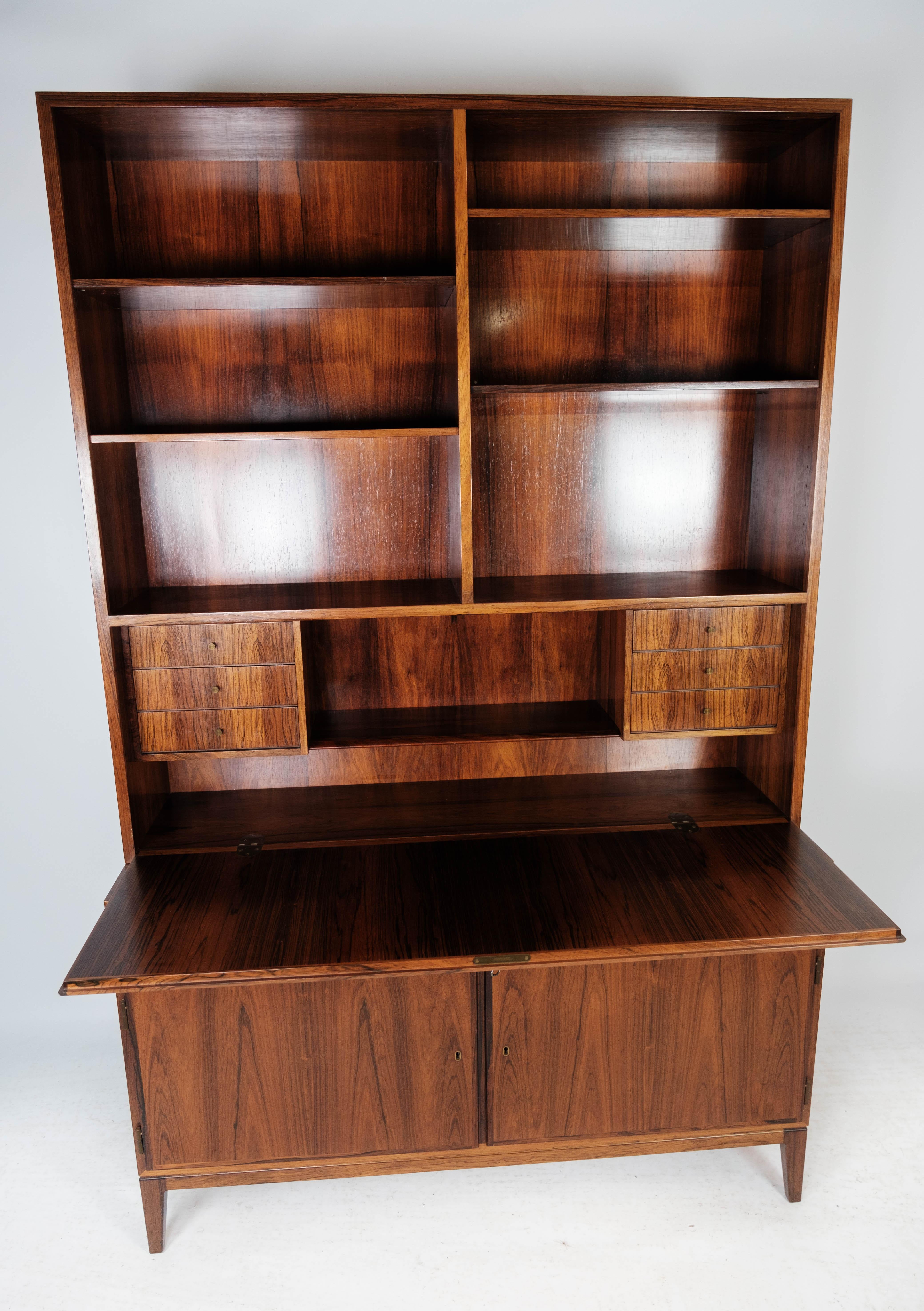 Tall secretaire in rosewood of danish design from the 1960s. The cabinet is in great vintage condition.