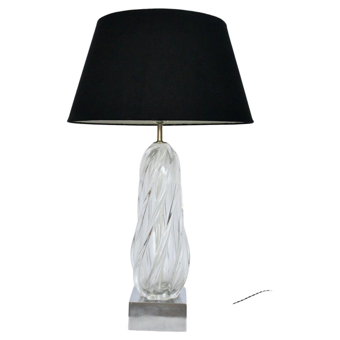 Substantial handcrafted transparent Seguso murano glass scalloped table lamp. Featuring a clear heavy, thick and smoothly ribbed hand blown glass atop a (6 W x 6 D x 3 H) square textured chrome plated block base. 33 H to top of finial. 25H to top of