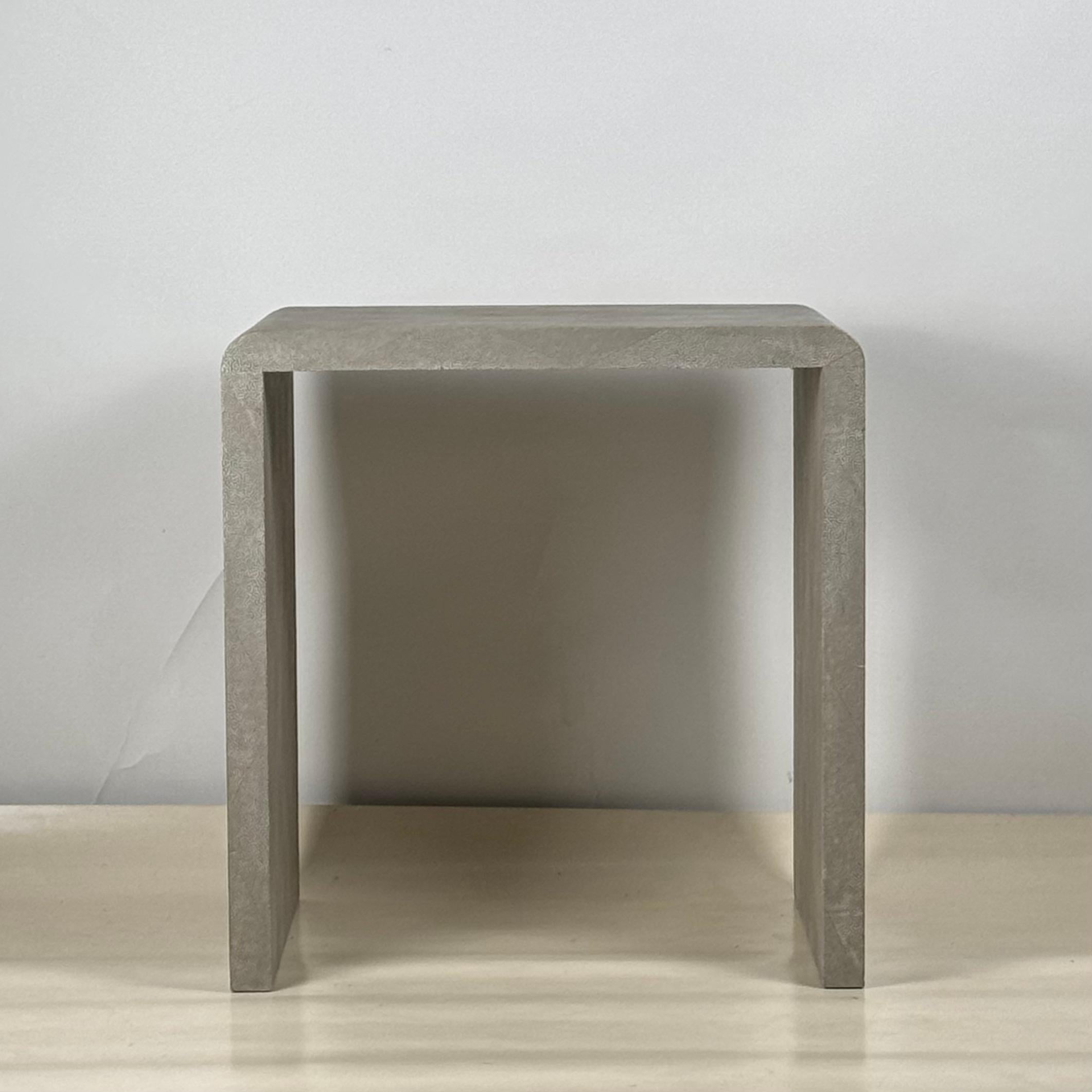Elegant faux-shagreen side table in the style of Jean Michel-Frank. This piece is a delightful nod to the iconic era of French Art Deco and will elevate any interior with its subtle textural presence.