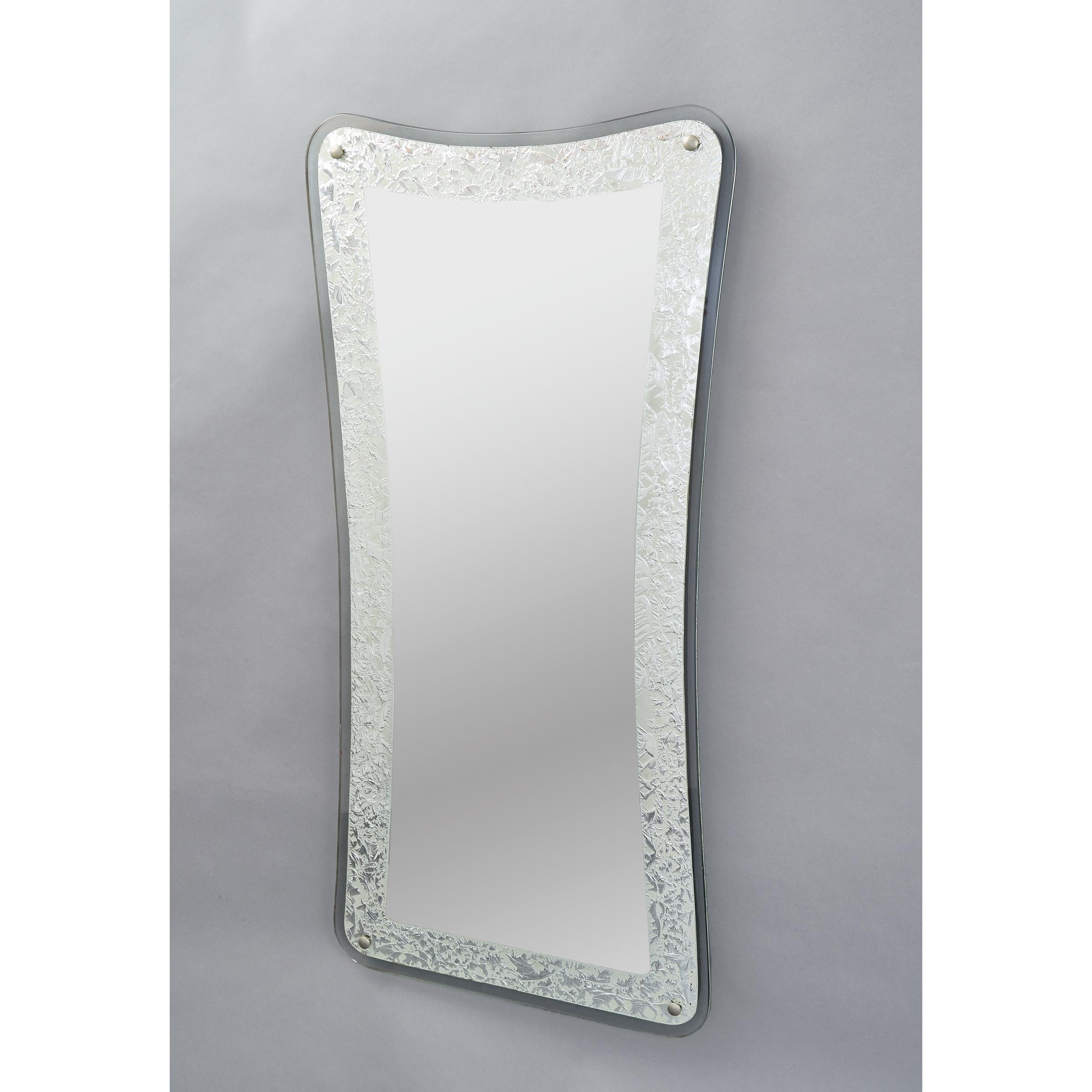 Italy, 1950s
Tall shaped mirror with textured silver foil ornemental border
Measures: 47 H x 22 W x 1 D.