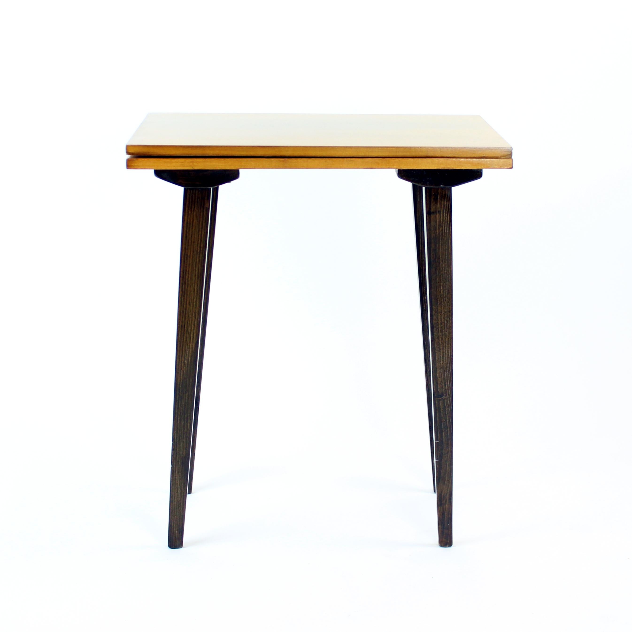 Great tall side table produced in Czechoslovakia in 1960s. The table was originally used as a TV table for the big TV sets from the past. Hence the turning top board. The top board is double and the top part has a mechanism which allows it to turn