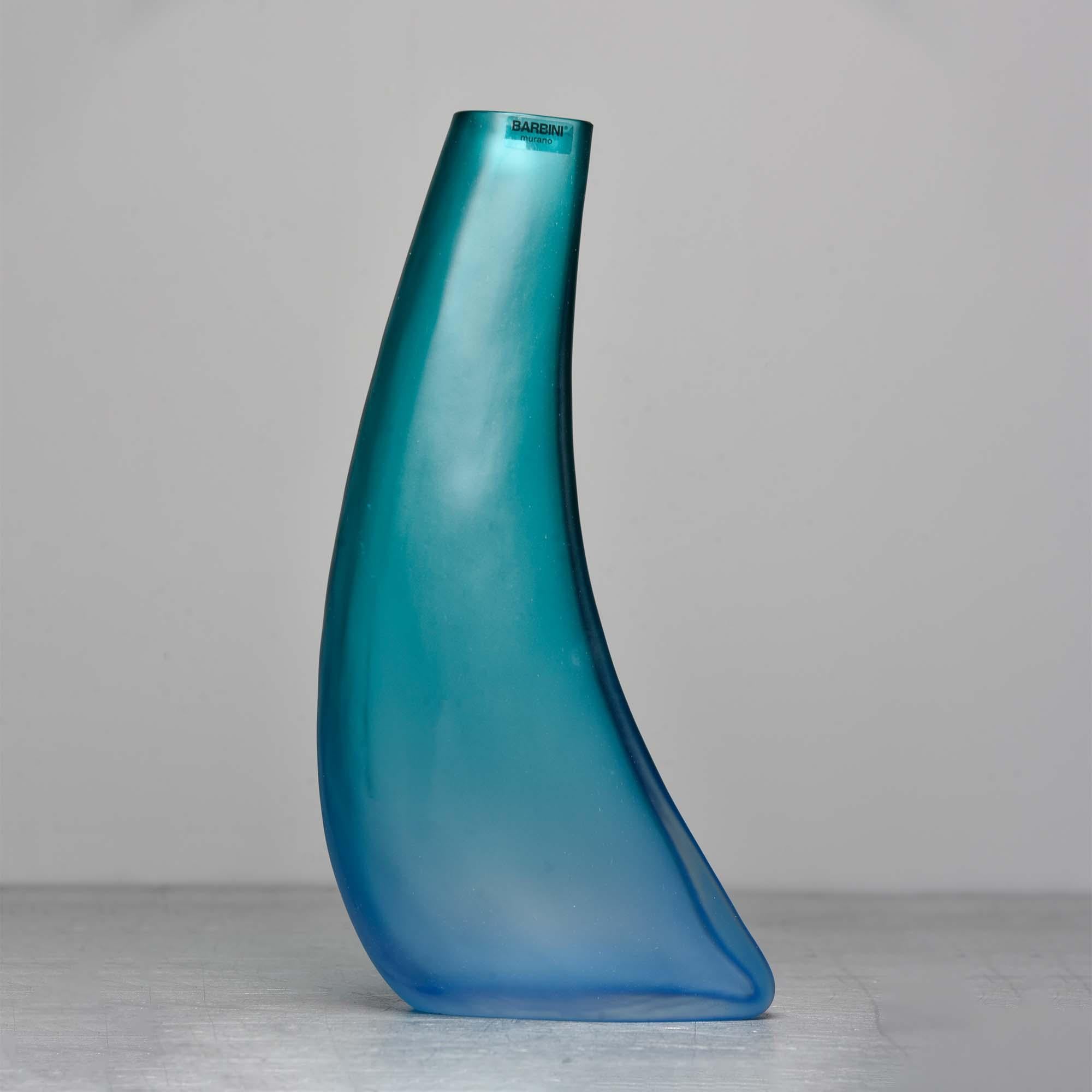 Circa 2010 Barbini of Murano tall, curved glass vase in ombre style that transitions from Caribbean sea green at top to sky blue at base. Original label affixed and signature is etched on base. Unused condition.
