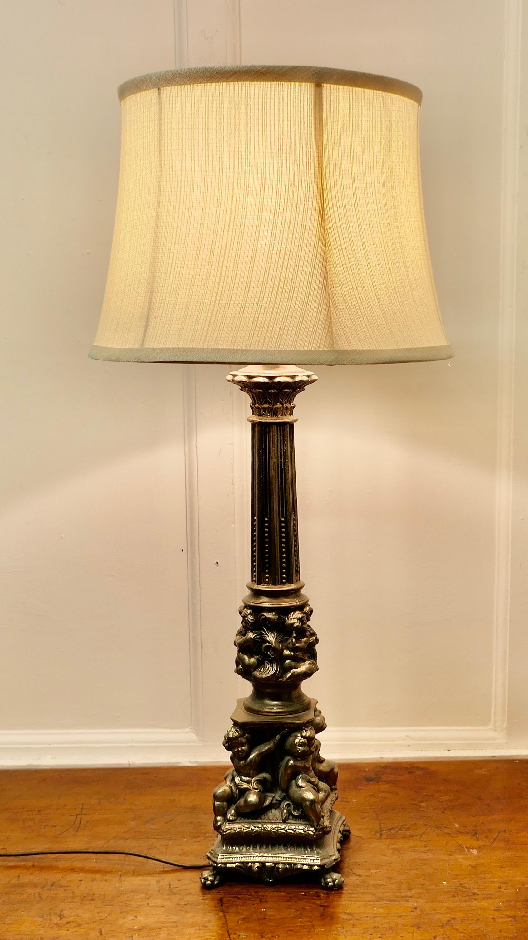 Tall Silver Gilt Metal Table Lamp with Putti

This lamp is made in silver gilt metal, and it has a Corinthian column to the centre with playful cherubs around the stepped base
The Lamp shade can be included if requested 
The lamp is 25” tall, and 6”