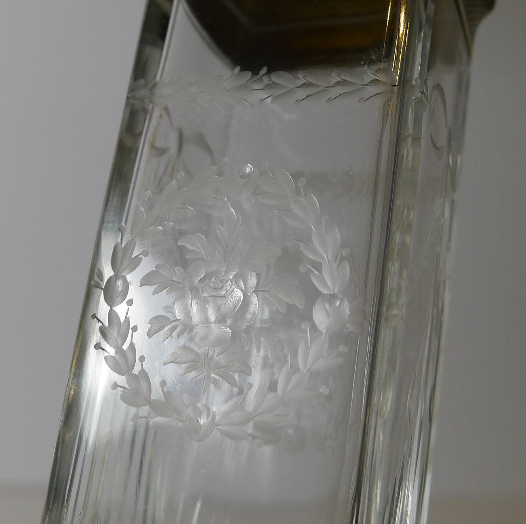 A stunning tall vanity / dressing table jar, probably used for either hatpins or a toothbrush, hence the little cork lining to the interior of the base.

The glass is channel cut and then hand -engraved with the prettiest floral and foliate design