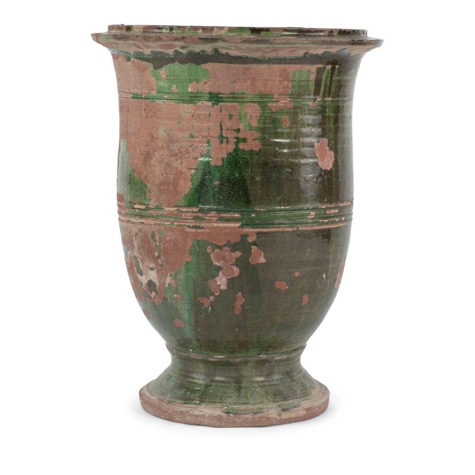 Tall slender green-glazed anduze jar, almost shaped like an olivette jar. Slight curve so body leans to one side. Circa early 1900s.
