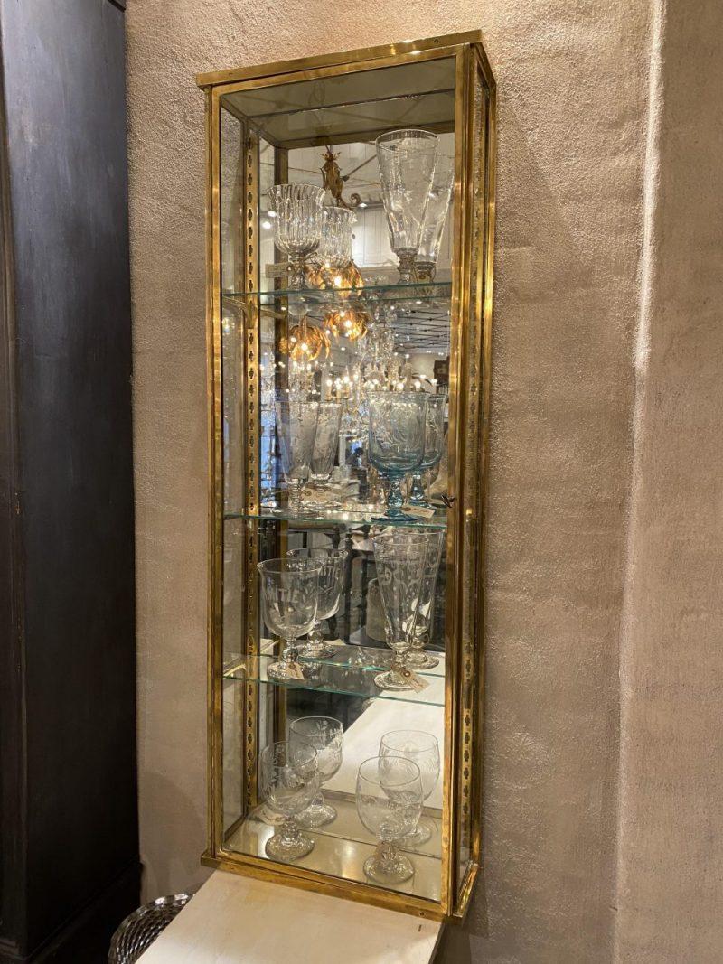 Handsome old French brass display cabinet from around the year 1900, in classic Art Nouveau style, which one can see on the charming brass shelf jacks.

Equipped with a large glass door with associated lock and key, 3 adjustable glass shelves and a