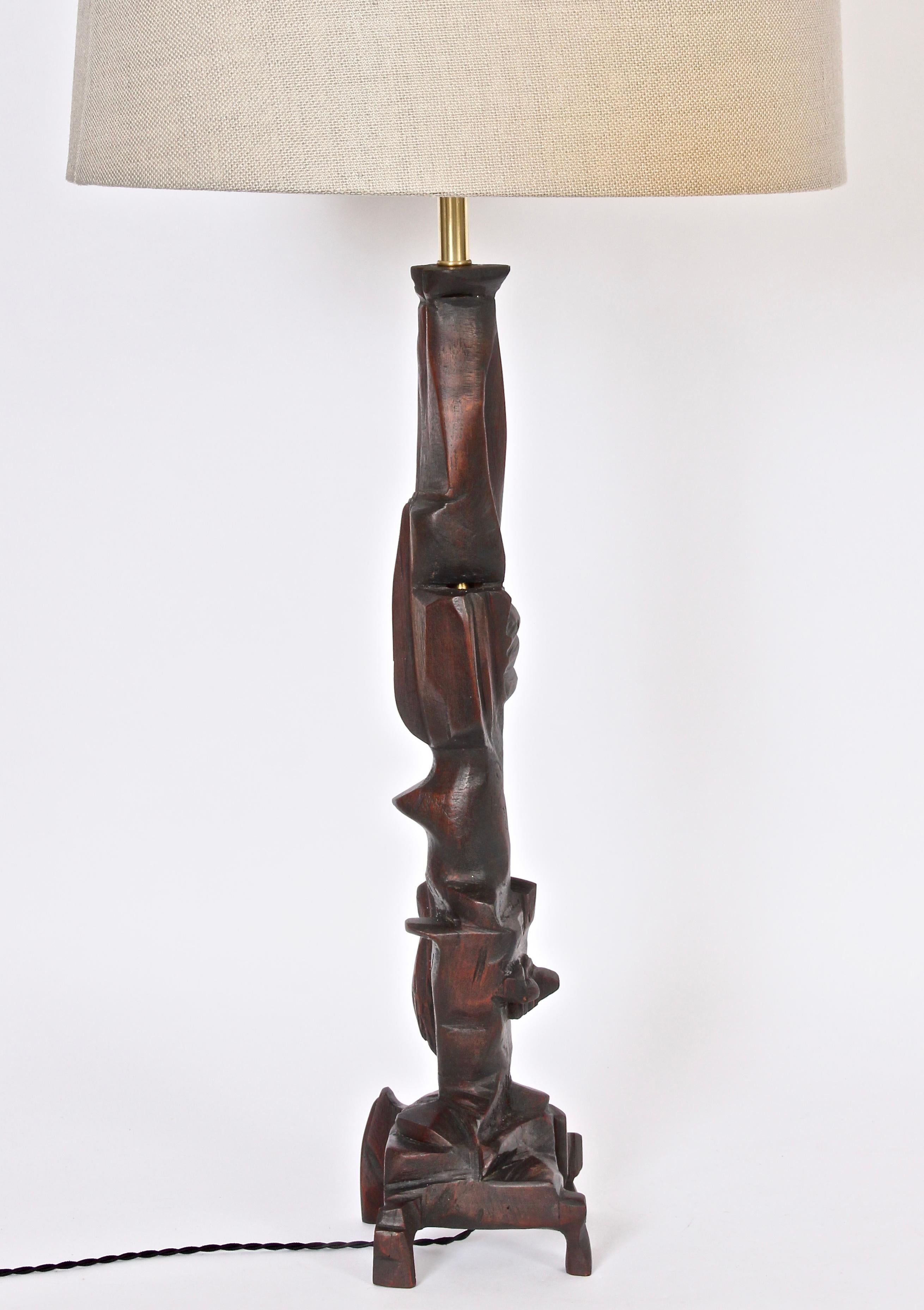 Tall handcrafted asymmetric wooden table lamp by New York artist, Smokey Tunis. Featuring a hand carved sculptural idiosyncratic form in stained Poplar. Small footprint. Shade shown for display only (10H x 17D top x 18D bottom). 31 H top of socket.