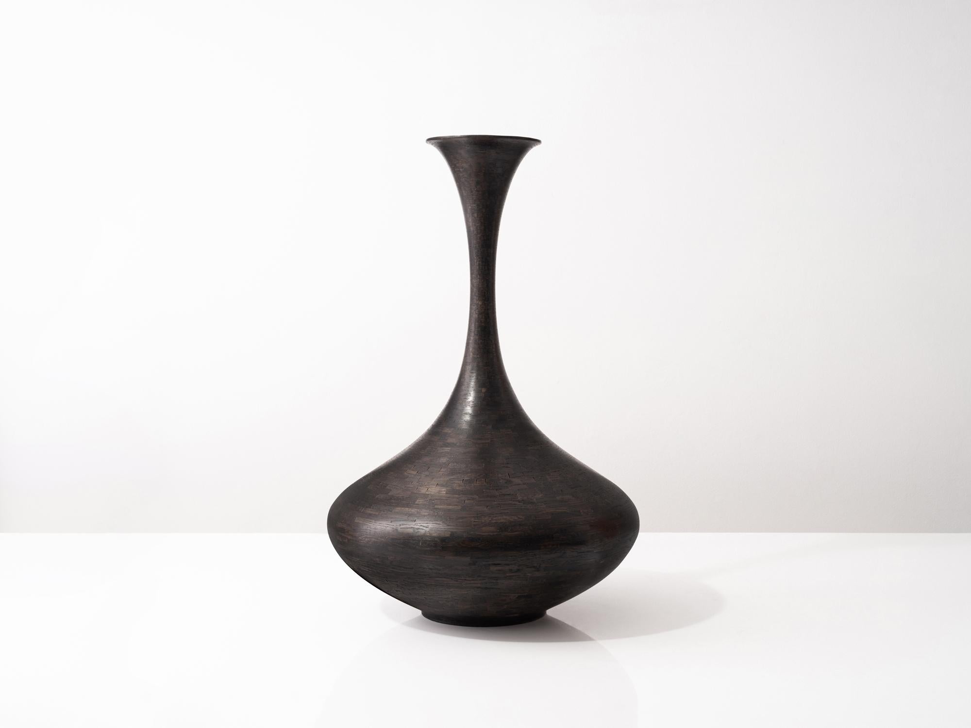 Part of Richard Haining's STACKED Collection, this wooden vessel with its elongated neck is made from reclaimed oak. The salvaged wood offcuts were sourced from a variety of local Brooklyn wood shops, as well as from deconstructed turn of the