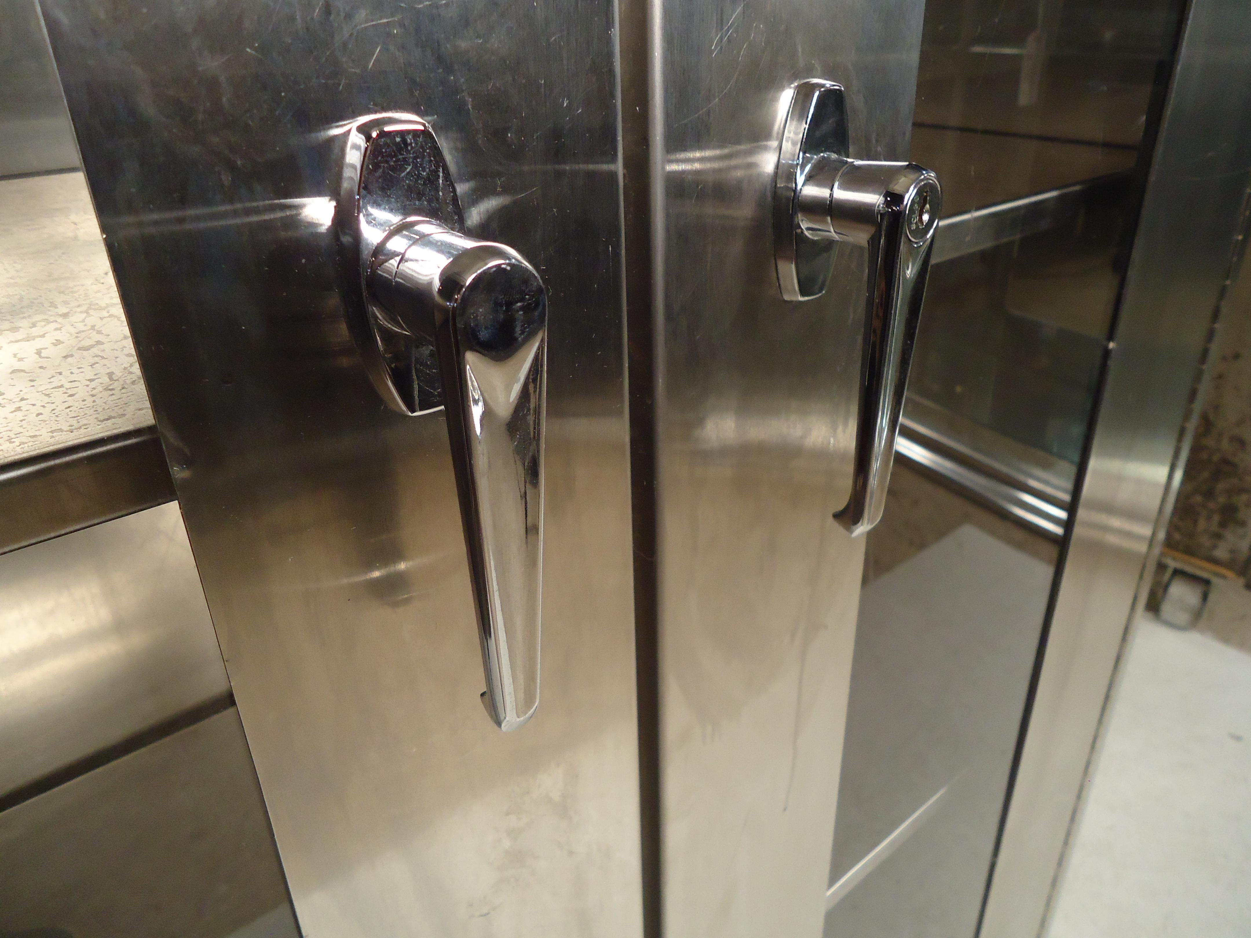 Double door stainless steel cabinet with three adjustable shelves. No key, but the handle has a locking mechanism.

(Please confirm item location - NY or NJ - with dealer).
 
