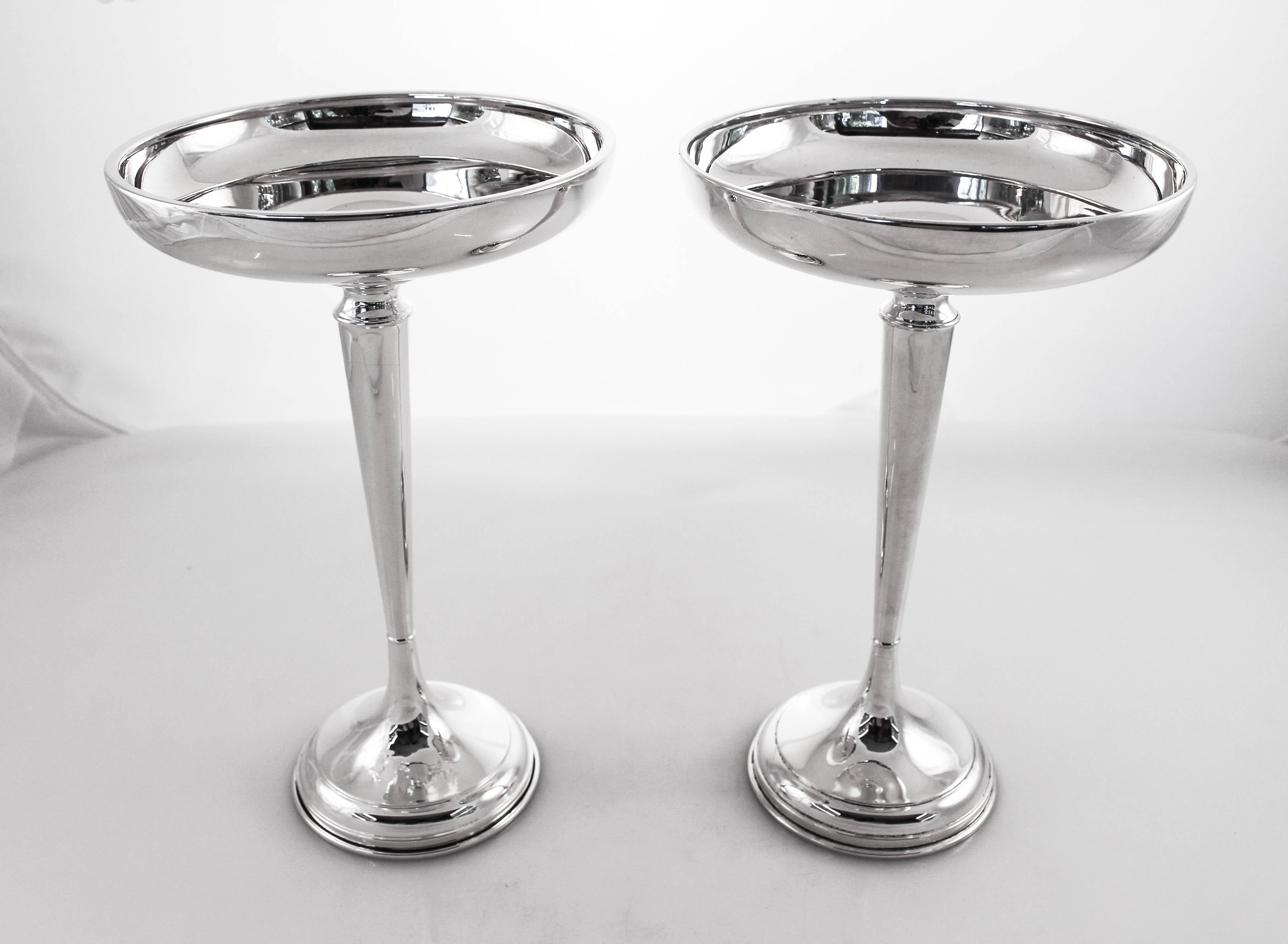 We are proud to offer this pair of sterling silver compotes that were retailed by the world famous J. E. Caldwell & Co store in Philadelphia. They are super clean; no etchings or decoration. The top has a rim that curves up insuring whatever is in