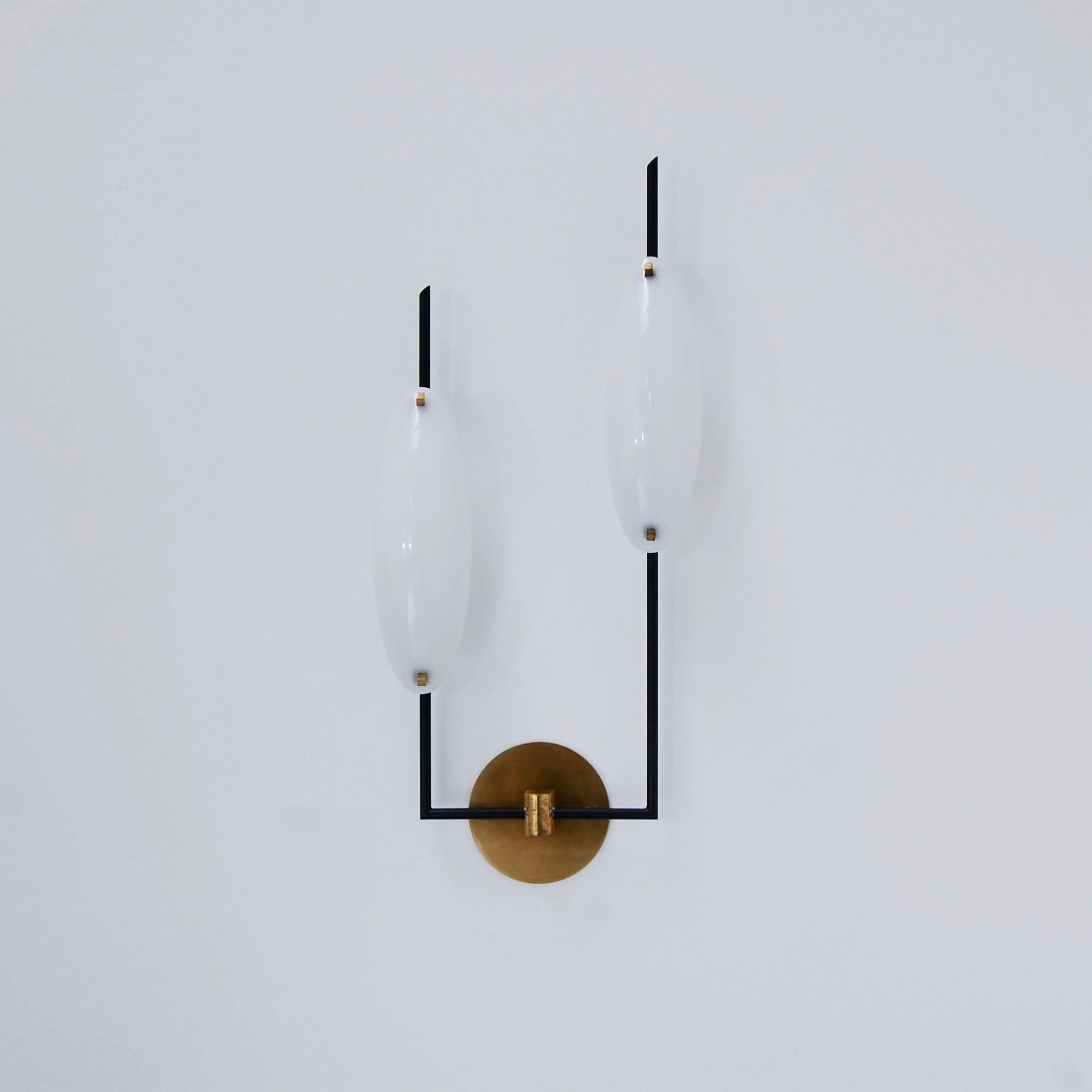 Elegant pair of modern tall sconces by Stilnovo of Italy. Mid-Century Modern 1950s of the period sconces. Patinated brass hardware finish and acrylic shades. Single E12 candelabra based socket per shade (2 per sconce). Currently wired for use in the