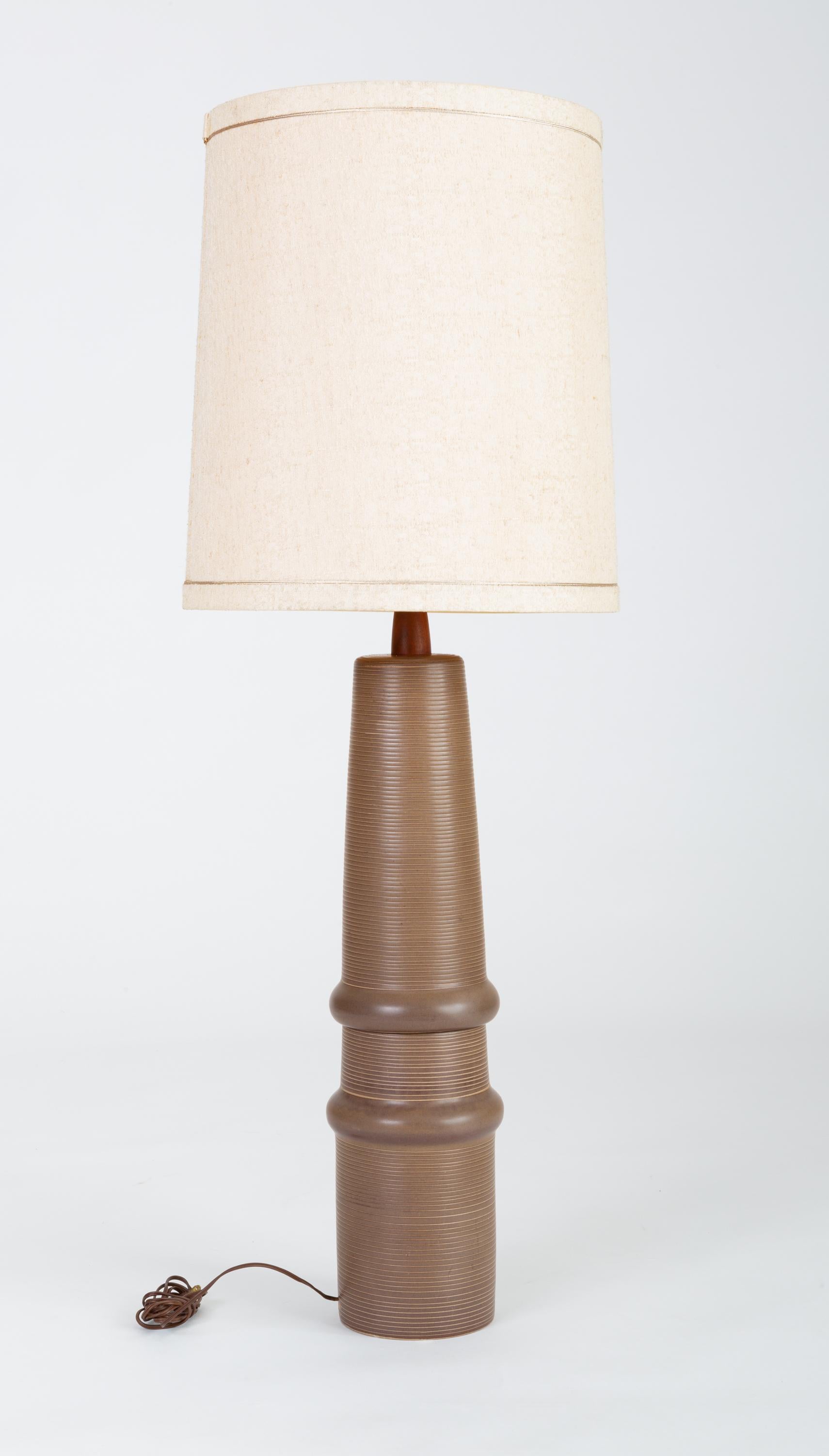 A tall ceramic lamp by husband-and-wife design team Gordon and Jane Martz. Produced by their family company, Marshall Studios in Indiana beginning in 1957, the Model 172 lamp has an organic form with a ribbed texture produced by horizontal incising,
