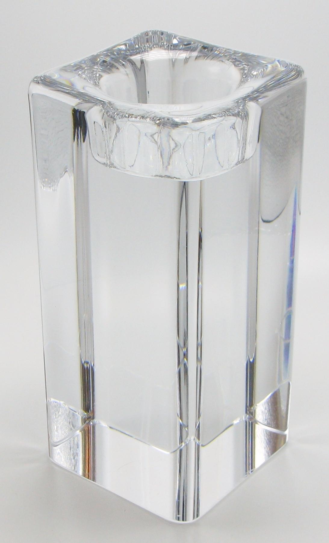 Tall 1980s Swedish glass block candleholder by Goran Warff.
Votive candle appears to float within the crystal block, creating a beautiful ambiance. Signed and numbered with engraved signatures, Kosta, and Warff.