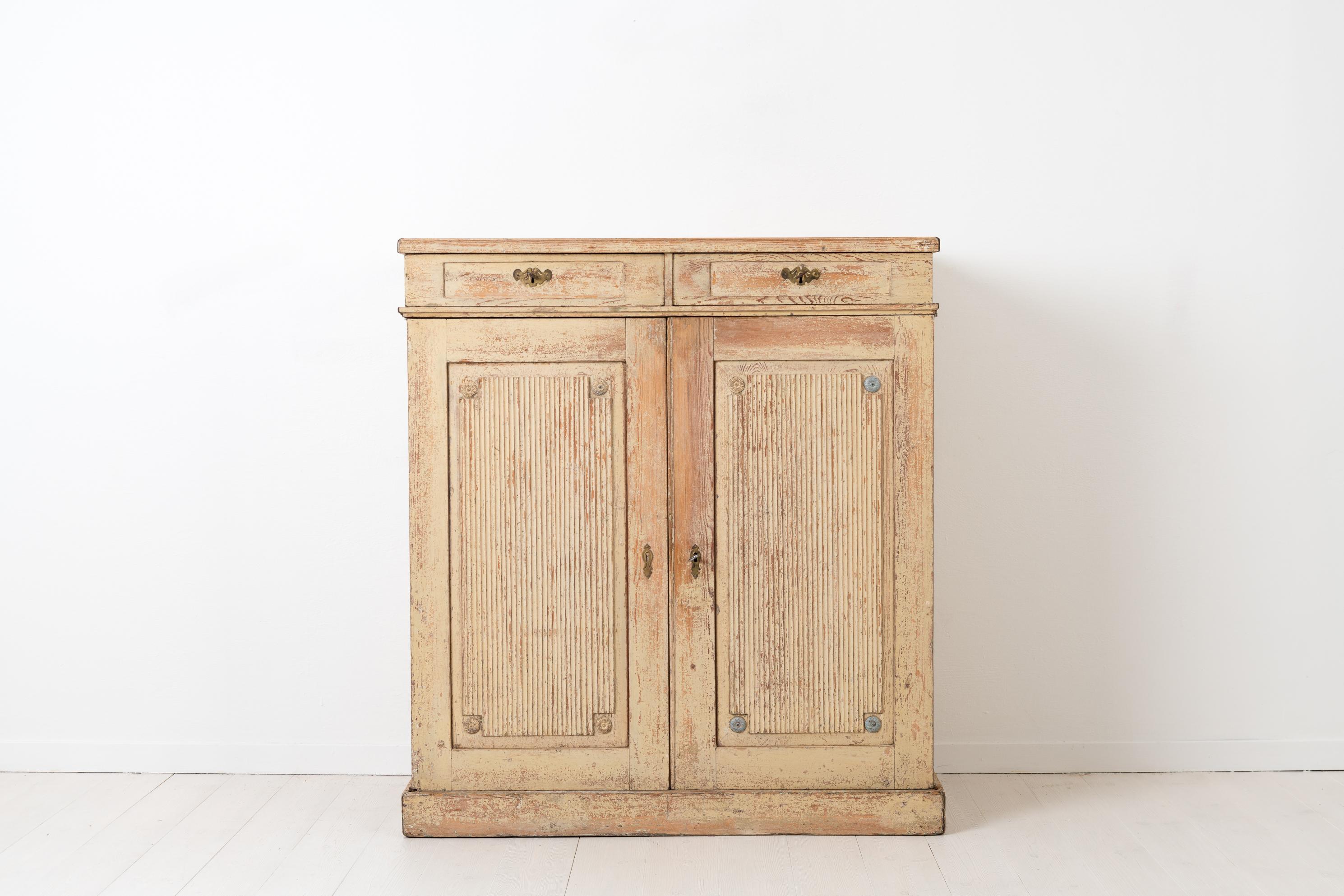Gustavian sideboard from Sweden made circa 1800-1810. The sideboard is from the end of the Gustavian period and has original distressed paint and original hardware. Made in pine and hand scraped to original paint from the first years of the 19th