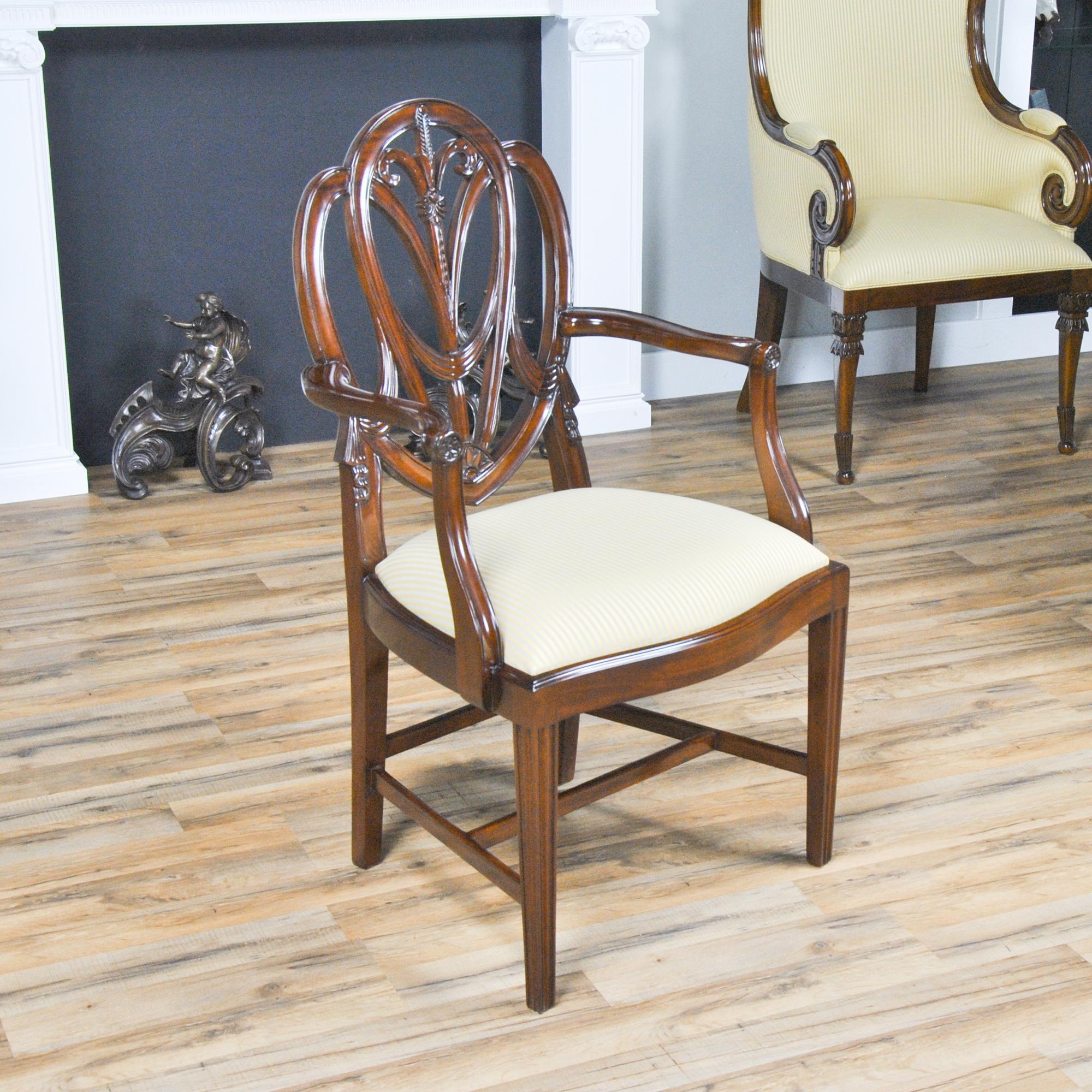 This fine quality set of 10 Tall Sweet Heart Chairs consists of 2 arm chairs and eight side chairs. Each chair has an elegant and stylish back carved from solid mahogany and featuring Drape Carvings as well as interconnected loops crested by a Fleur