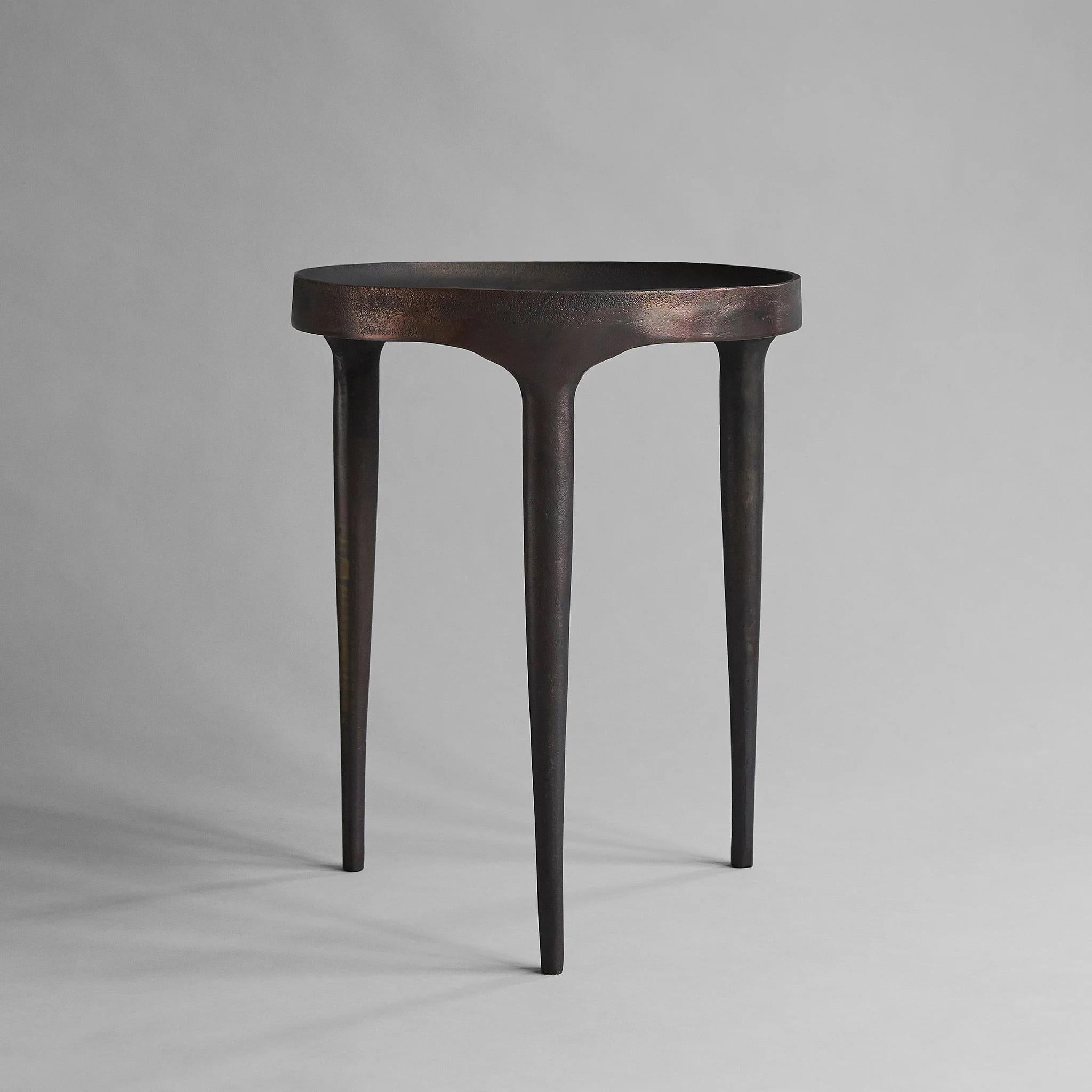 High table, end of sofa or side table in cast aluminium, antique brown colour, contemporary work.

High table, end of sofa or side table in cast aluminium. It has an antique brown colour, hand-painted, with a rough, unpolished surface, highlighting