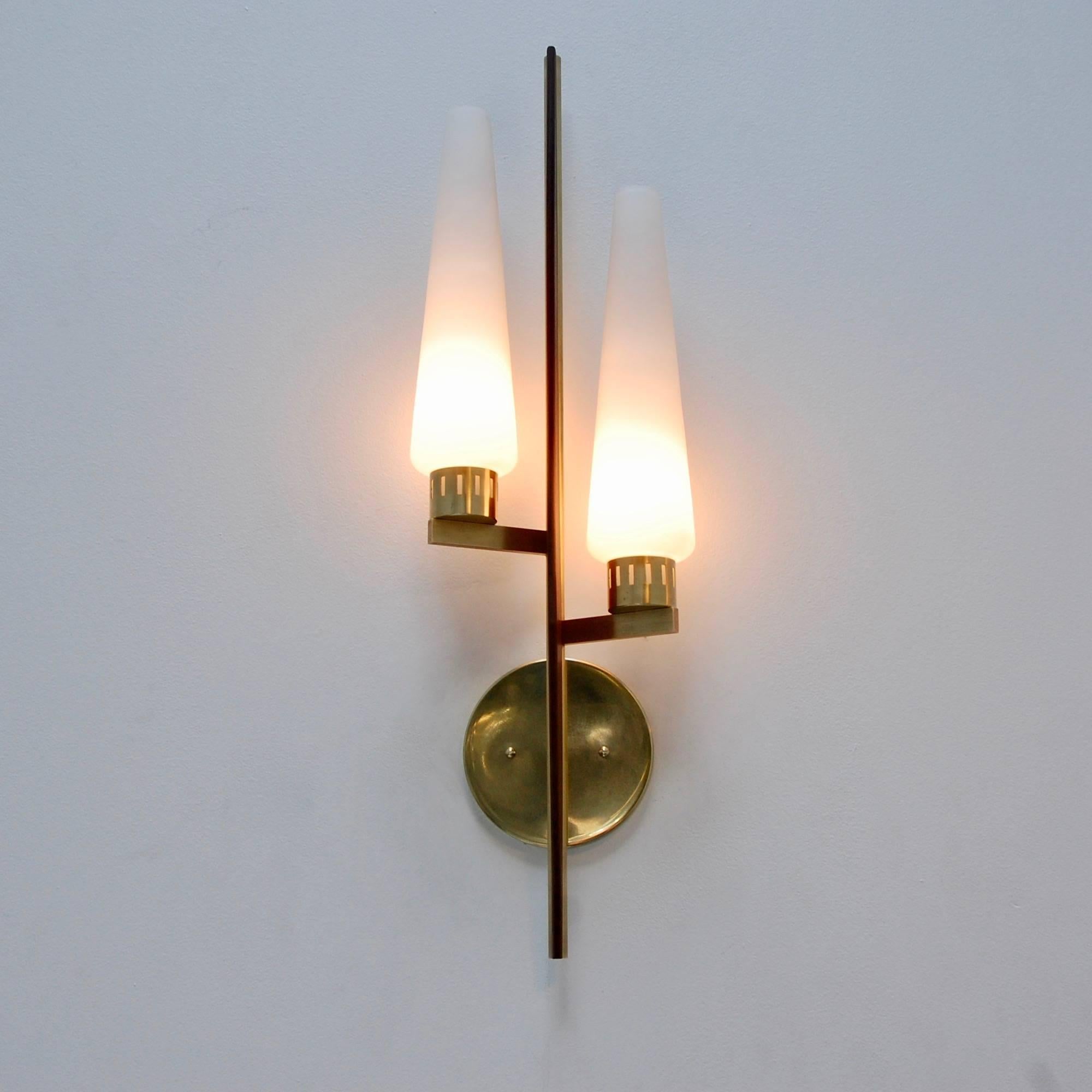 A pair of tall Classic 1950s teak sconces from Italy. Two glass shades per fixture. Partially restored, patina un-lacquered brass, teak wood and glass. Single E12 based socket per shade. Two per sconce. Maximum wattage 75 watts per shade. Currently