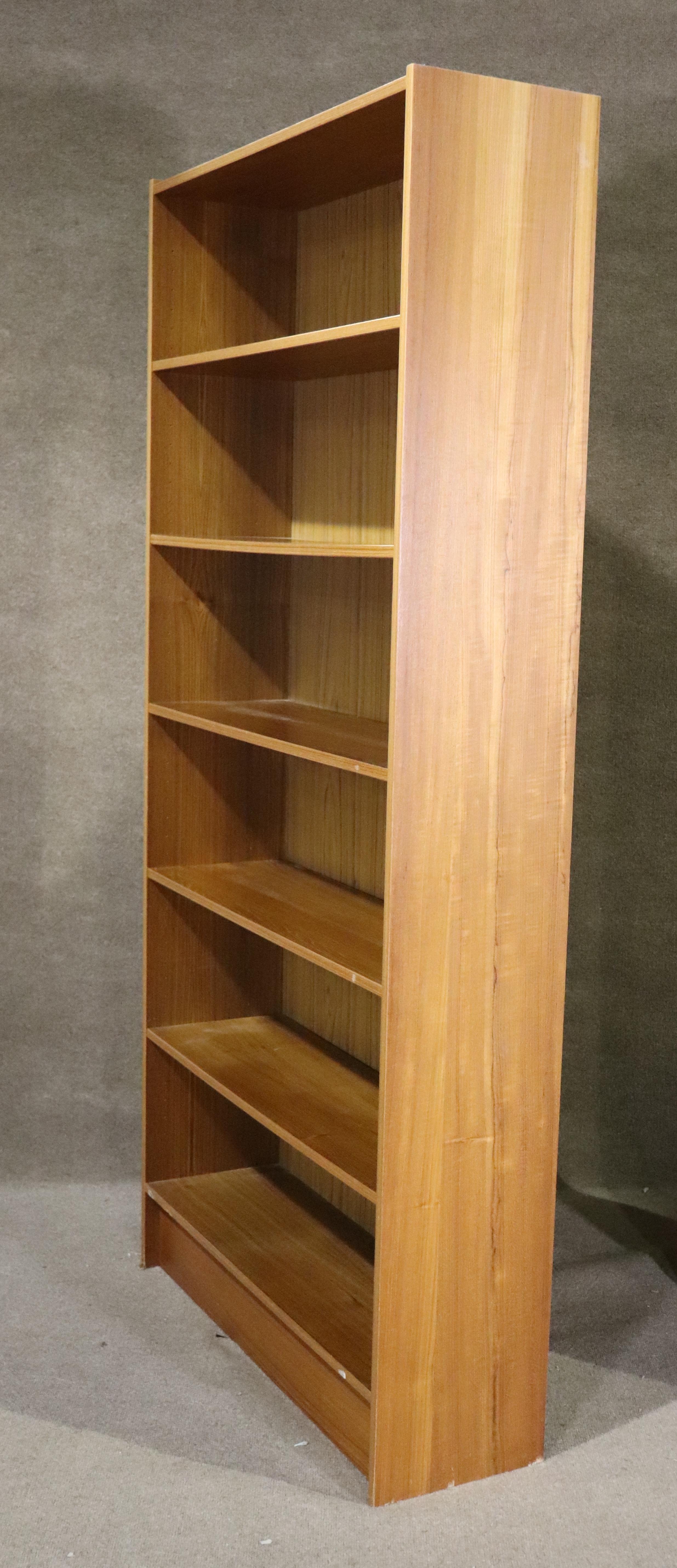 Large standing bookcase in teak veneer. Six wide shelves in a six foot tall unit.
Please confirm location NY or NJ