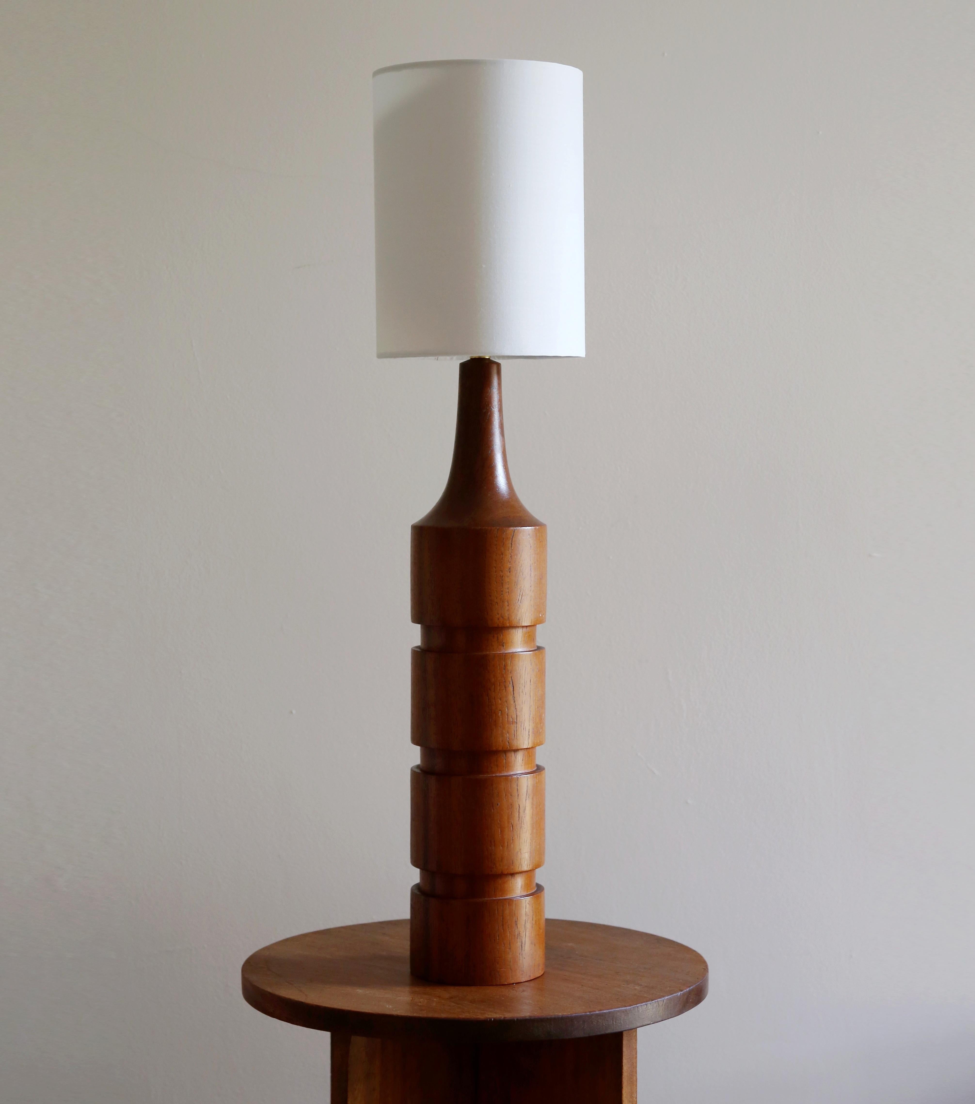Beautiful tall ringed Mid Century Danish teak lamp has been fully cleaned, restored and rewired.  A lovely example of Scandinavian minimalism, this lamp would fit in beautifully with a Mid Century interior
Likely dating back to the mid 1960s, the