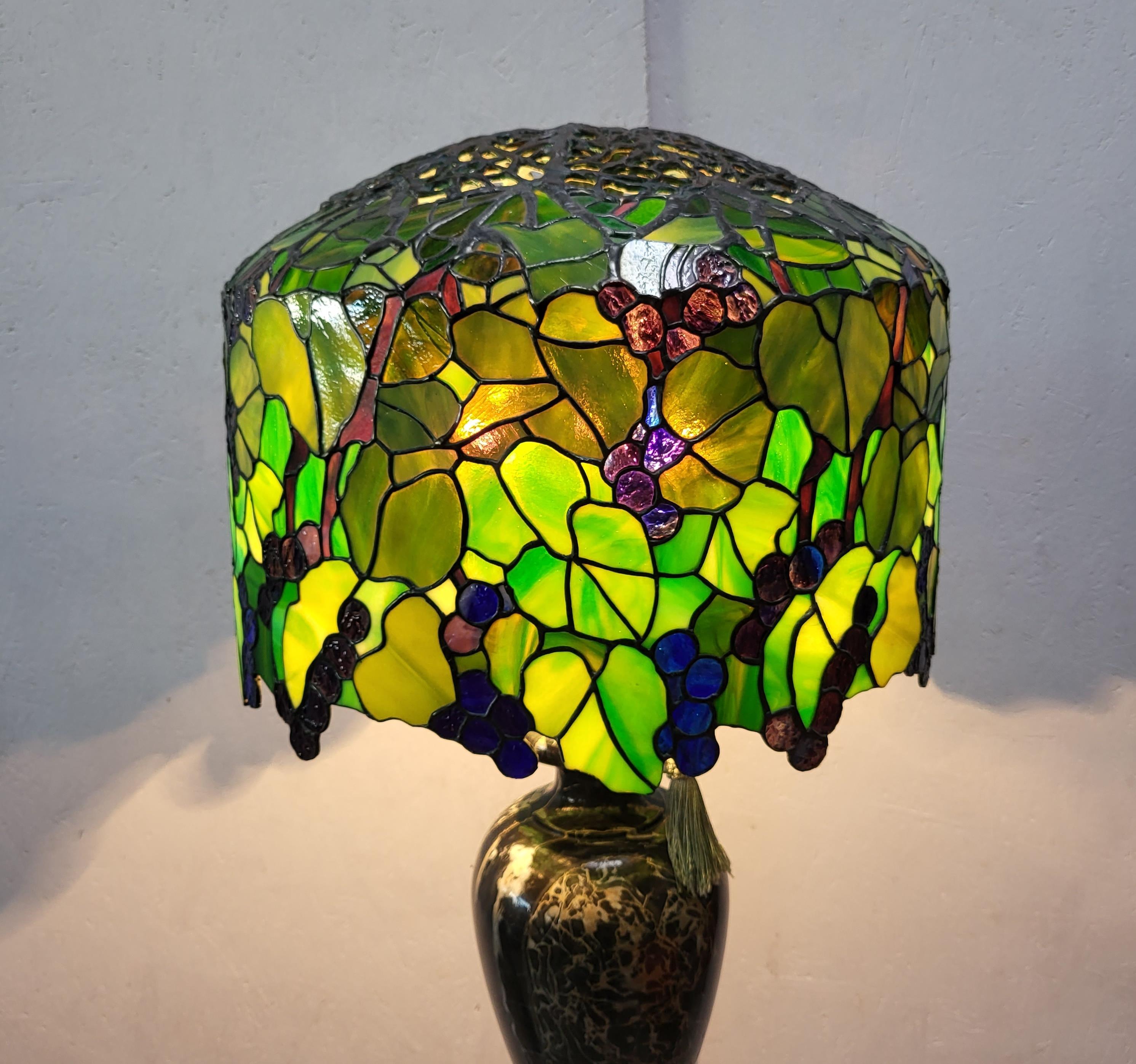 Stunning and amazing lamp in the manner of Tiffany Studios. 
Very impressive handmade lamp with a wonderful Breccia marble base.
 
Very fine handwork, colourful glass.

The lamp has an amazing warm light and is a wonderful art object.
It comes in a