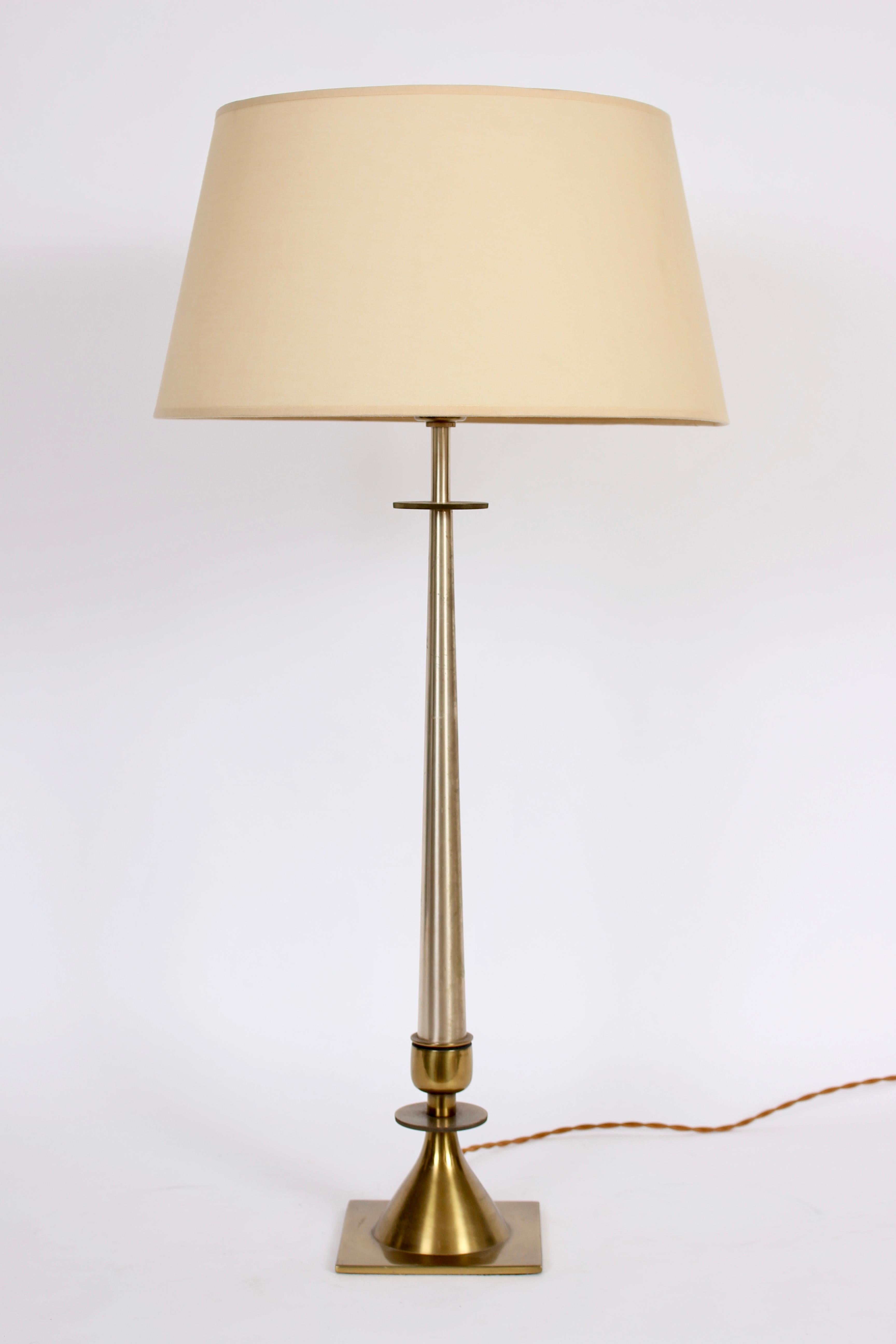 Substantial Hollywood Regency Stiffel brushed Brass & Nickel Plate Table Lamp. Circa 1960. Small footprint.  Featuring a tall slender reflective form approximately 3 feet tall, relaying a Gold and Silver affect. Includes White milk glass liner