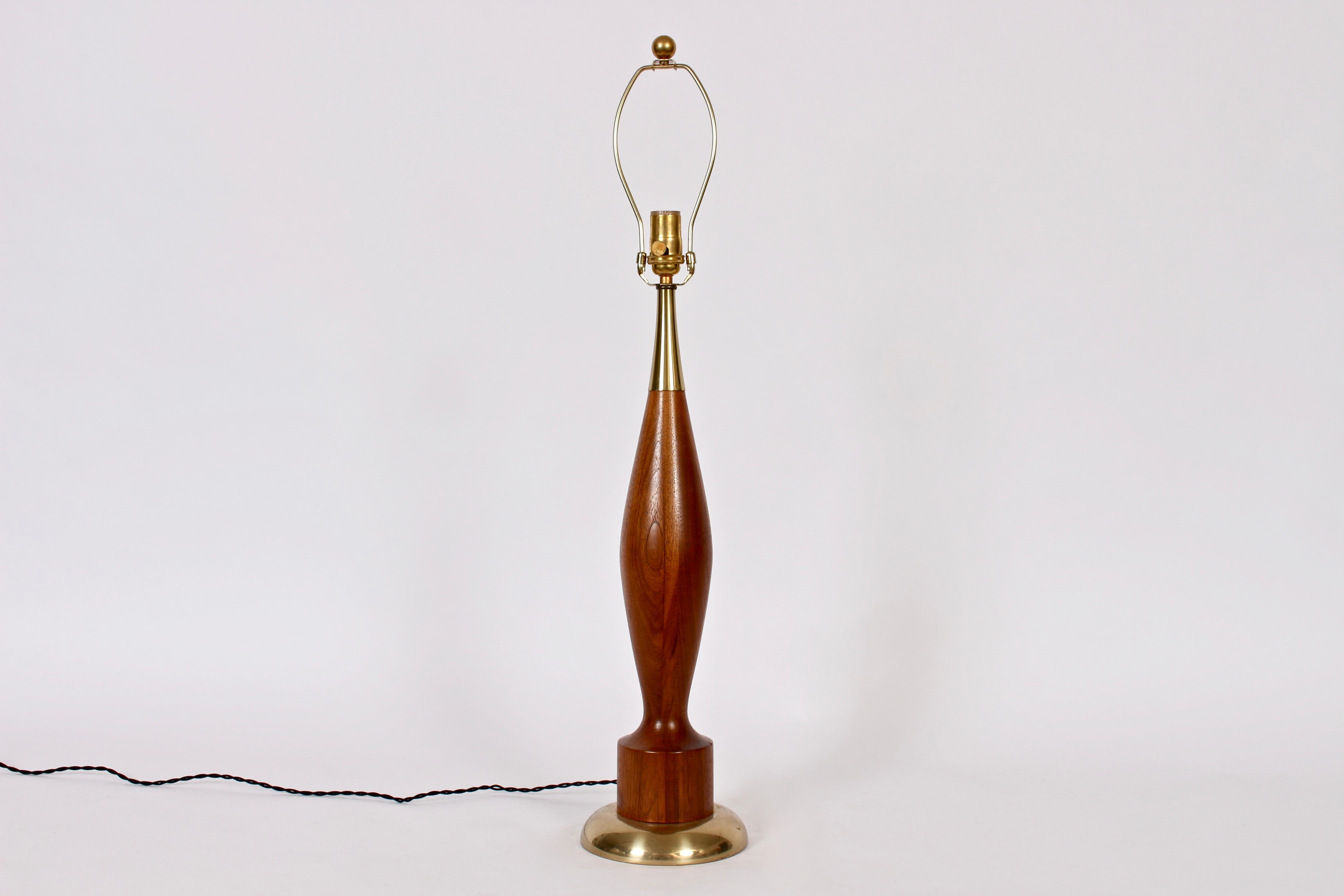 Substantial Tony Paul for Westwood Studios attributed, Walnut and Brass Table Lamp, circa 1960. Featuring a smooth turned Walnut bowling pin form, heightened circular base, rounded Brass base and capped with Brass detail. Small Footprint. 26H to top