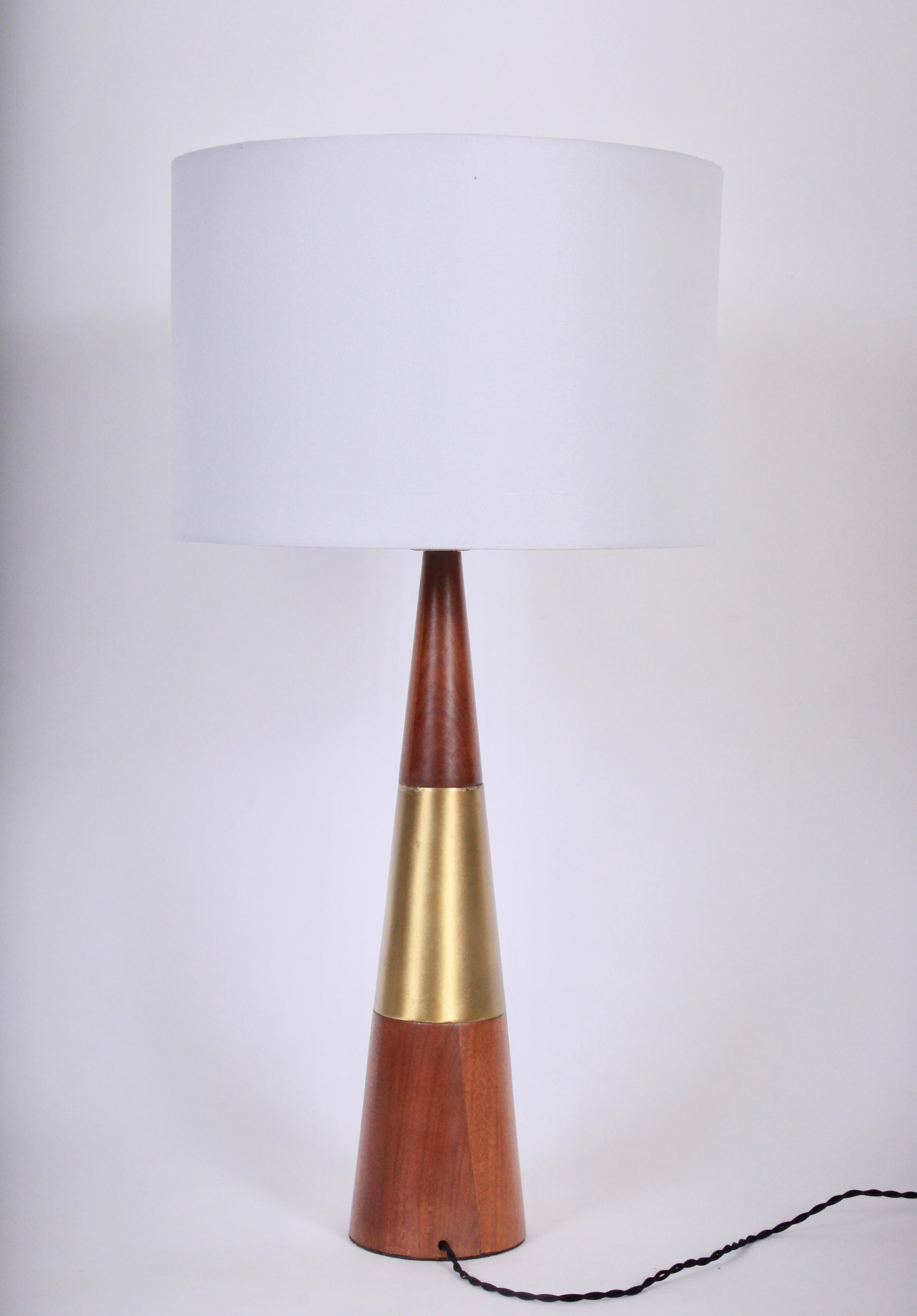 Tony Paul for Westwood Industries Cone Table Lamp in Swedish Brass & Solid Walnut. Circa 1960.  Featuring a sleek conical form in walnut and reflective bright brass. 21H to top of socket. Small footprint. Shade shown for display only and not for