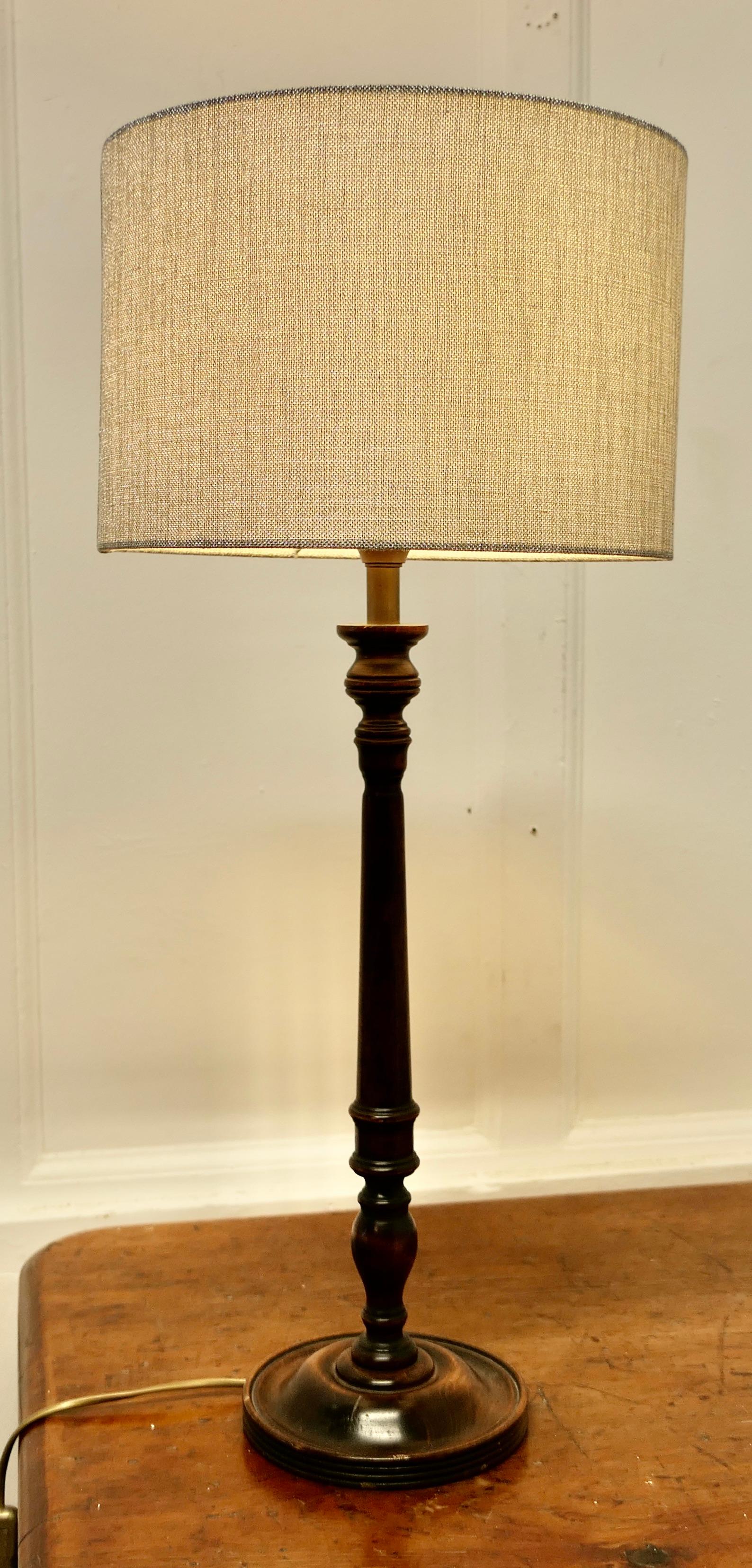 Tall Turned Dark Wood Table Lamp  

A good attractive table lamp made in beech in a dark finish, tall and sturdy and it comes with a silver/grey linen covered shade
The Lamp is 21” high, 7” diameter made the shade is 12” in diameter
SW101